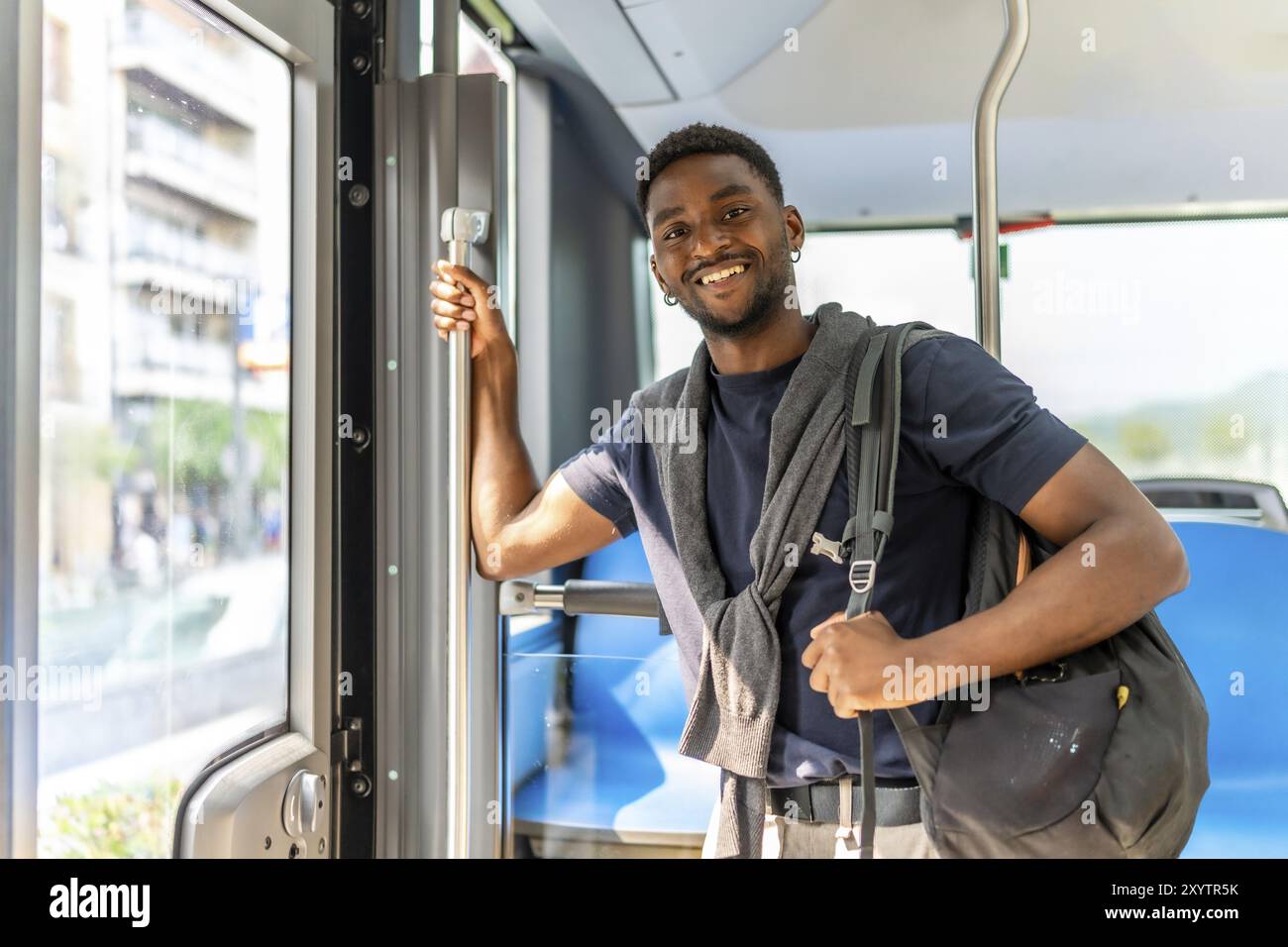 Confident handsome african student on the bus on the way to university Stock Photo