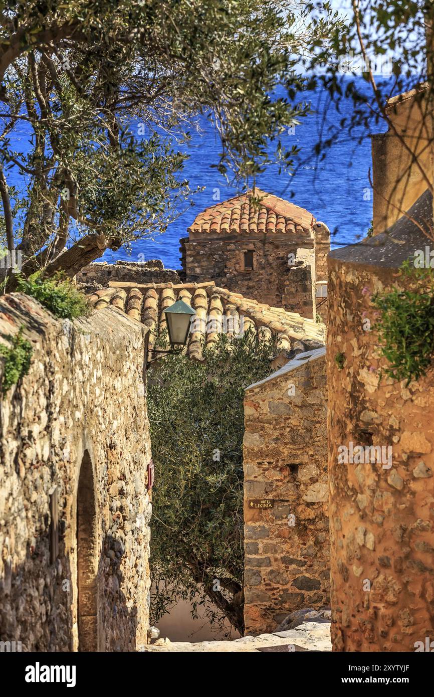 Monemvasia street view with old houses, roofs in ancient town and sea view, Peloponnese, Greece, Europe Stock Photo