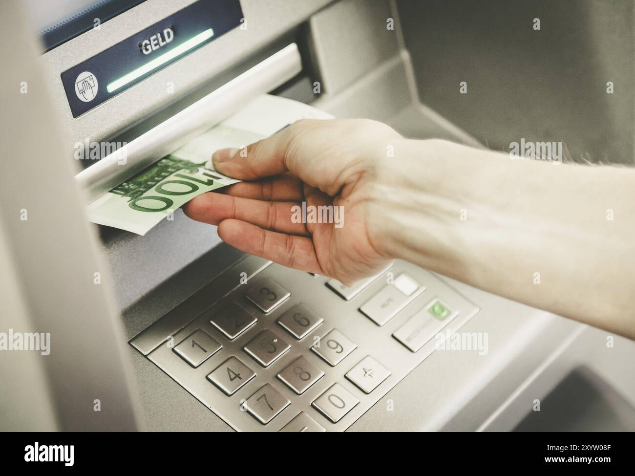 Young woman withdrawing money from a cash machine Stock Photo