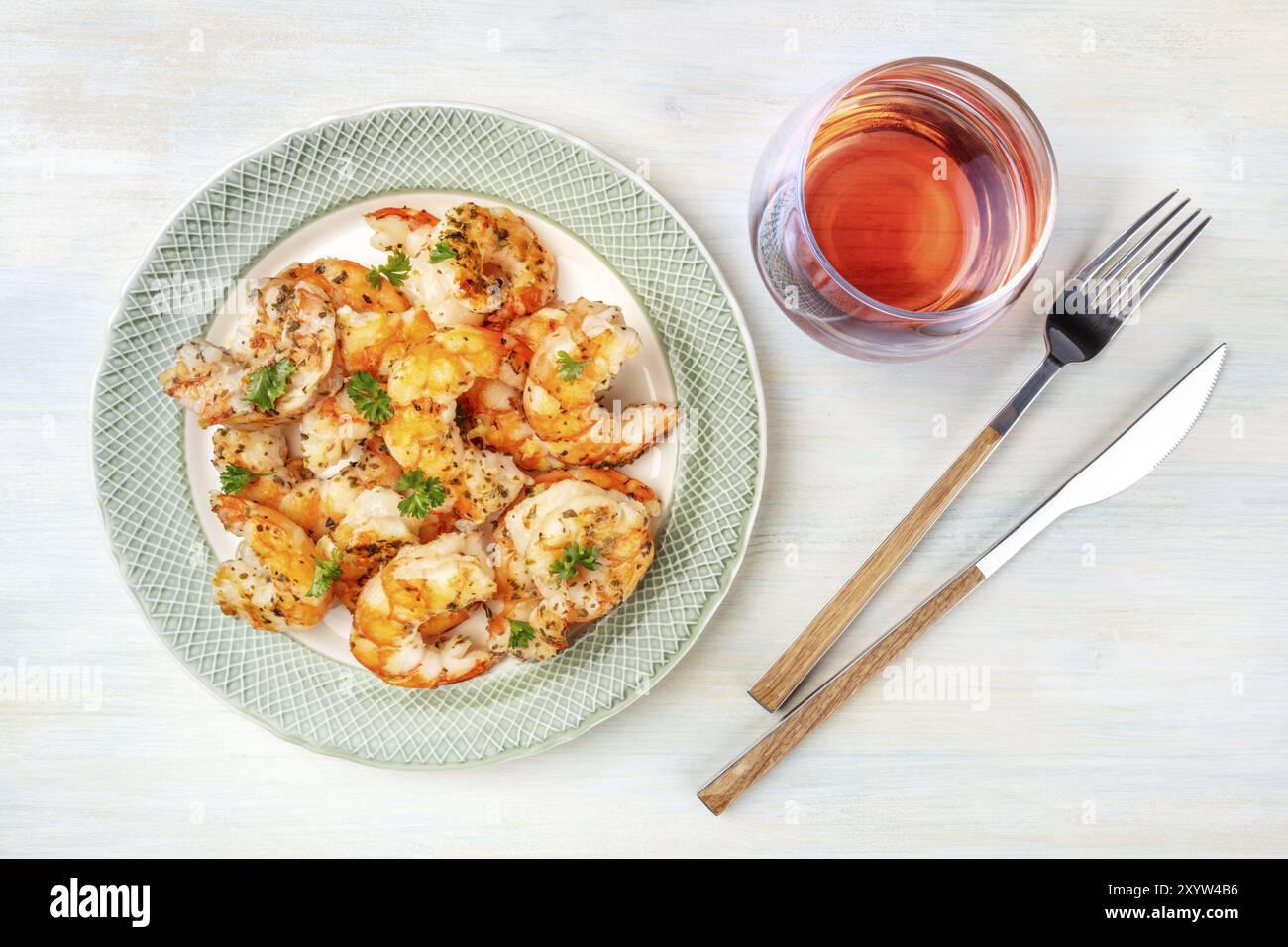 Fired shrimps with a glass of rose wine, shot from the top on a light blue background Stock Photo