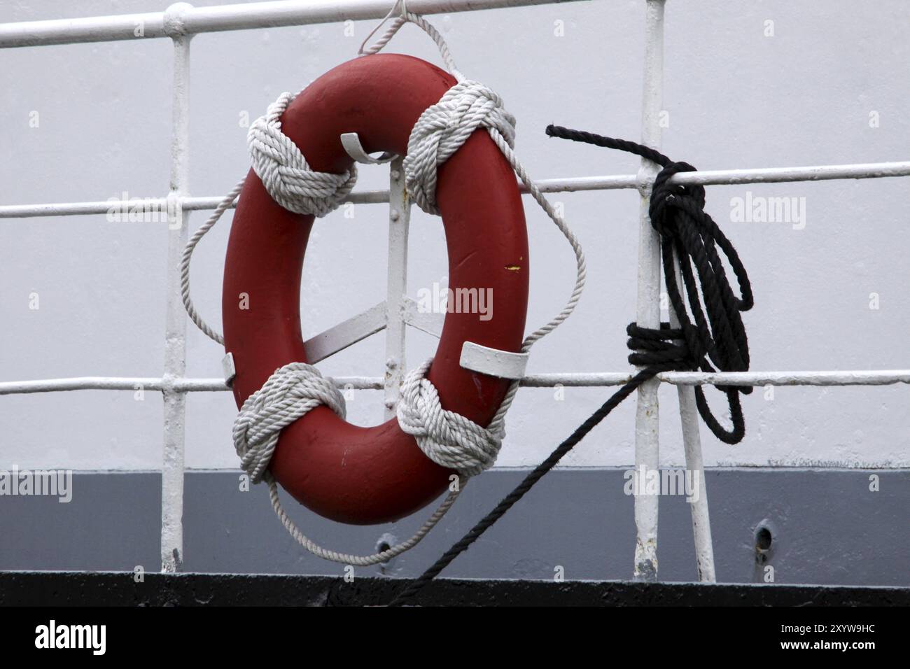Lifebuoy on a ship's railing Stock Photo - Alamy
