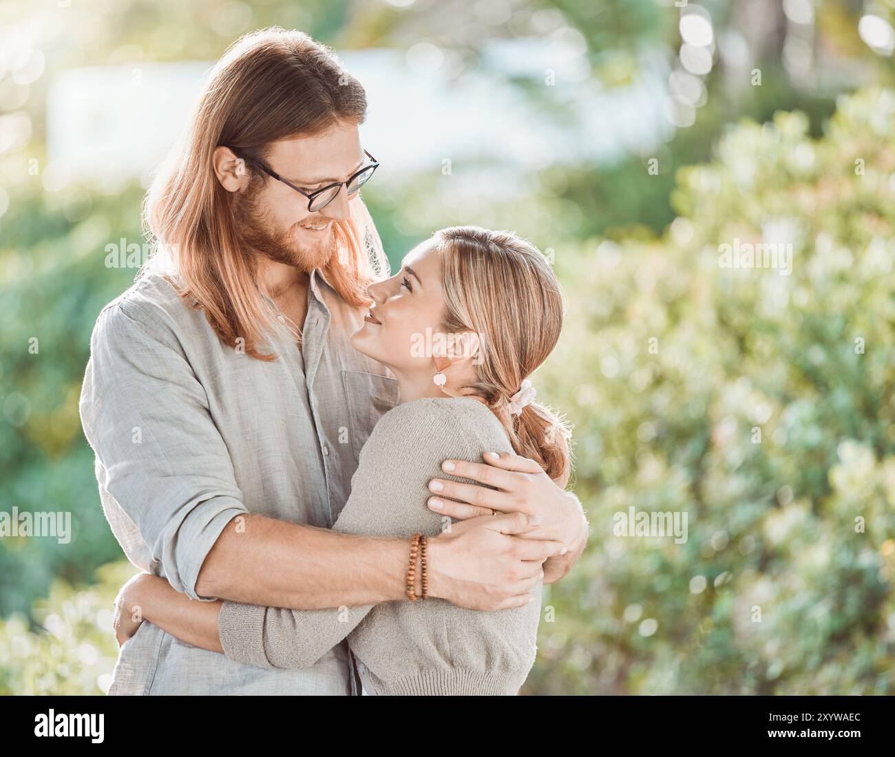 Couple, hug and smile for love in garden with care, bonding and outdoor ...