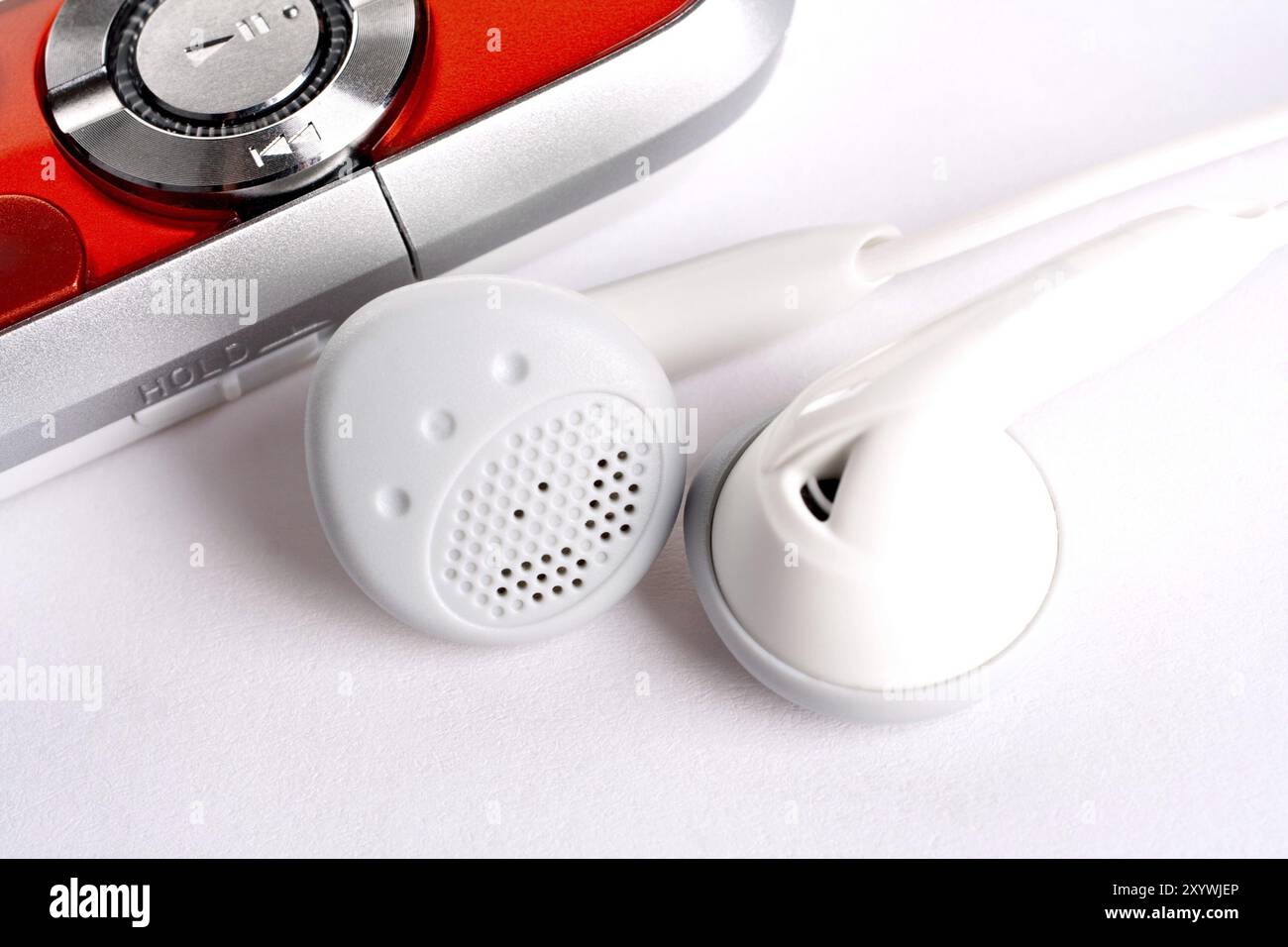 Mp3 player with headphoneson on a white background Stock Photo - Alamy