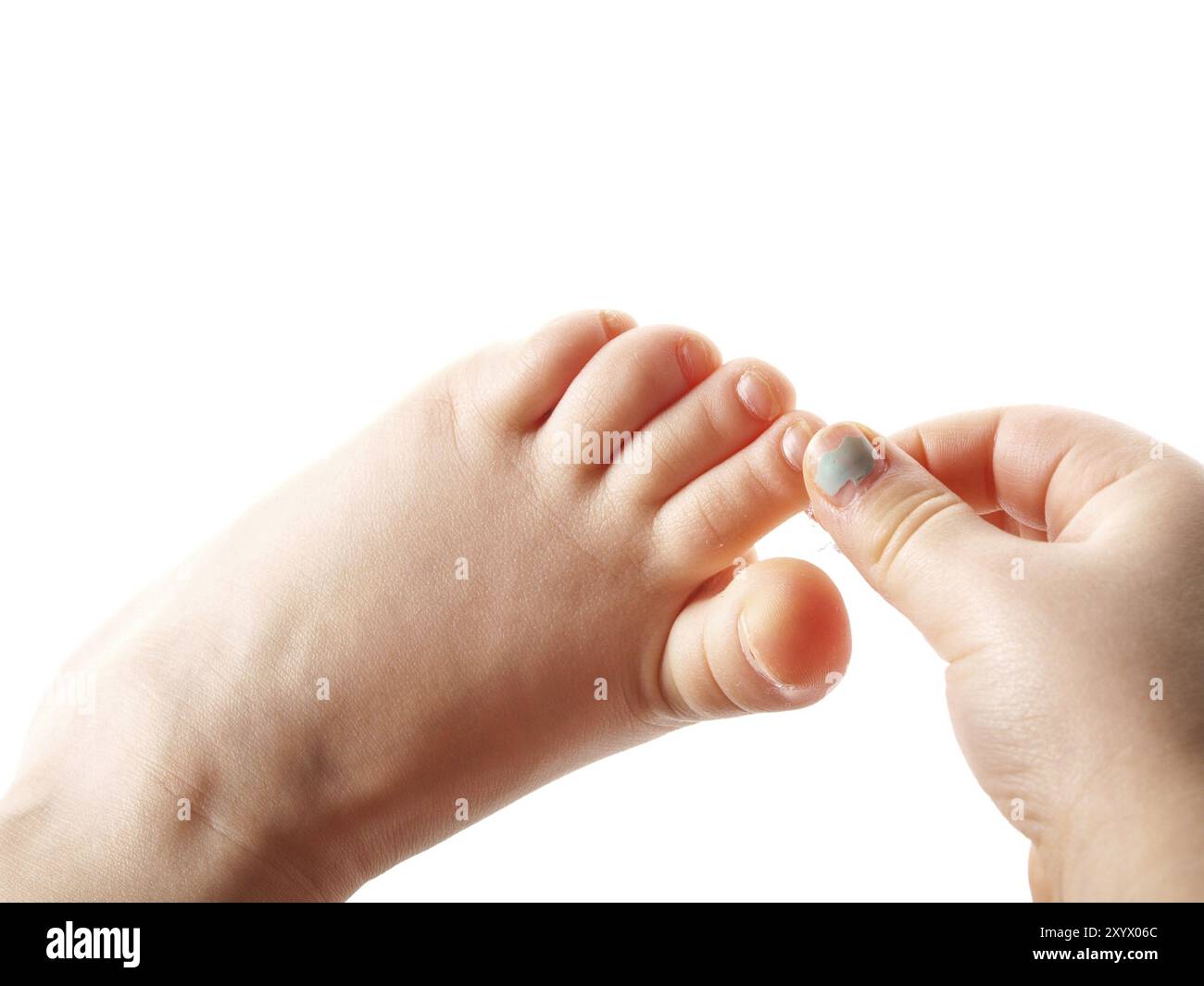 Girl grabbing toe on left foot with right fingers from right hand, isolated towards white background Stock Photo