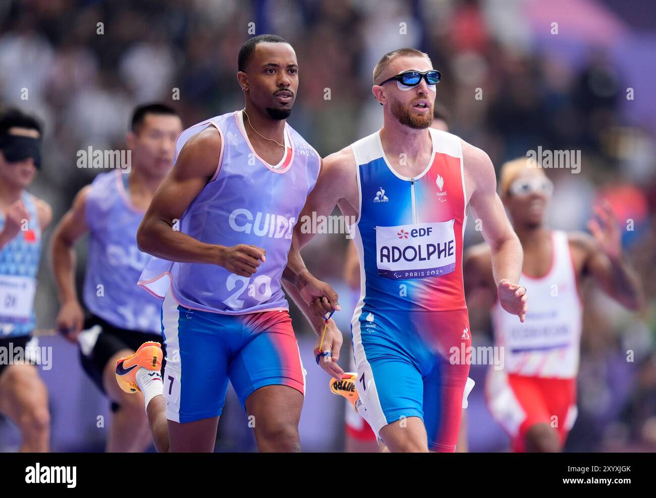 France's Timothee Adolphe (right) and his guide Jeffrey Lami compete in ...