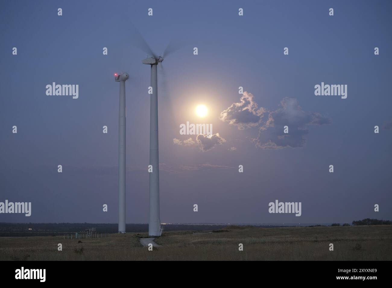 Wind station turbines and full moon at the sky Stock Photo - Alamy