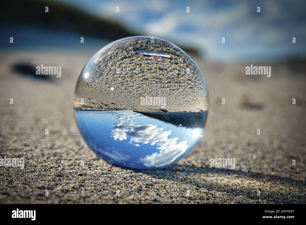 Glass sphere on the beach of the baltic sea. detailed close up of the ...