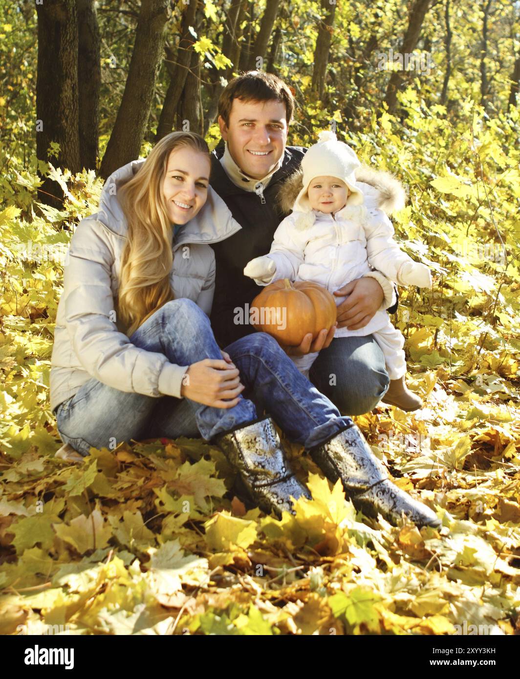 Young happy family with little daughter in autumn forest Stock Photo ...