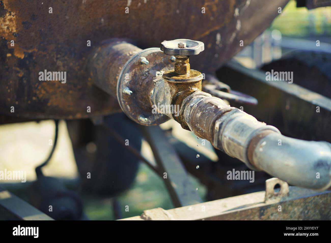 Dripping tap of a water tank in the open, Drops fall from the pipe ...