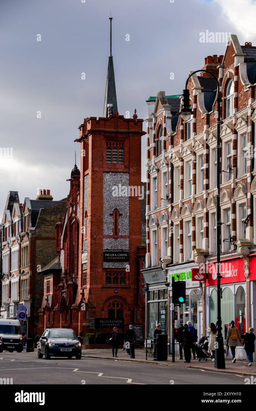 A vibrant London street showcasing historic red-brick architecture