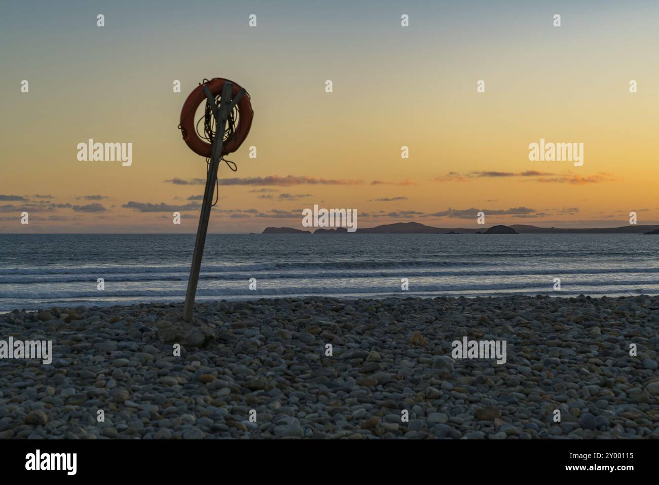 Lifebelt in the evening light on the pebble beach of Newgale, Pembrokeshire, Dyfed, Wales, UK Stock Photo