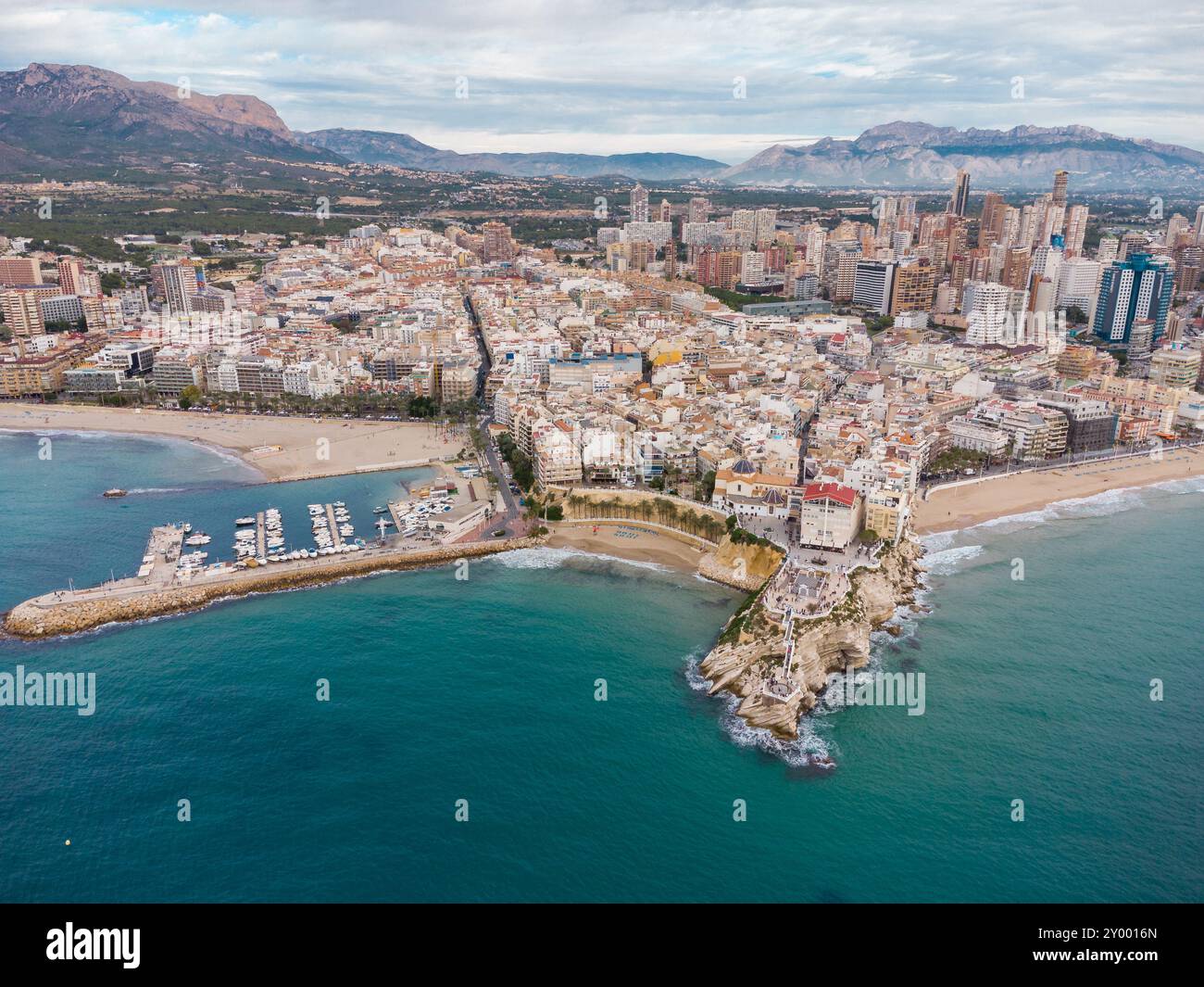 Aerial drone point of view of Benidorm city. Famous travel destination in Alicante province, Spain. Skyscrapers, mountains in background, Mediterranea Stock Photo