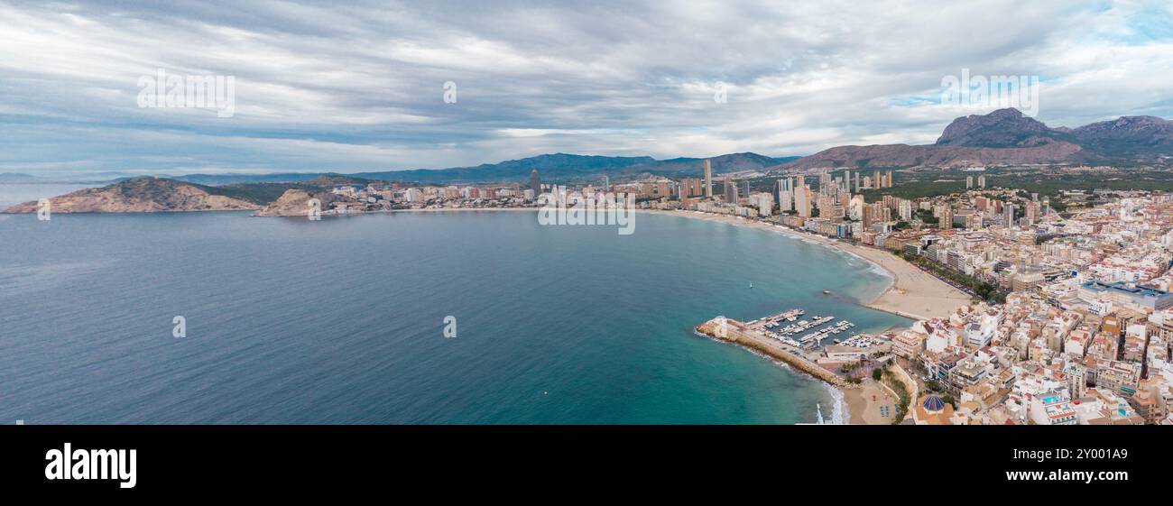 Aerial drone point of view of Benidorm city. Famous travel destination in Alicante province, Spain. Skyscrapers, mountains in background, Mediterranea Stock Photo