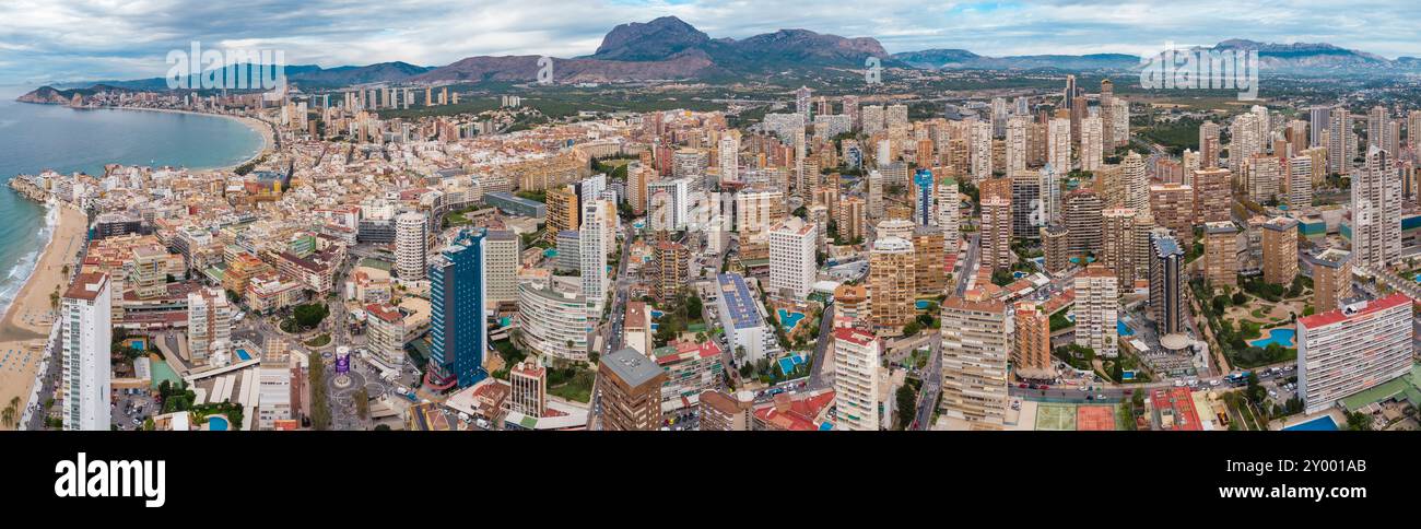 Aerial drone point of view of Benidorm city. Famous travel destination in Alicante province, Spain. Skyscrapers, mountains in background, Mediterranea Stock Photo