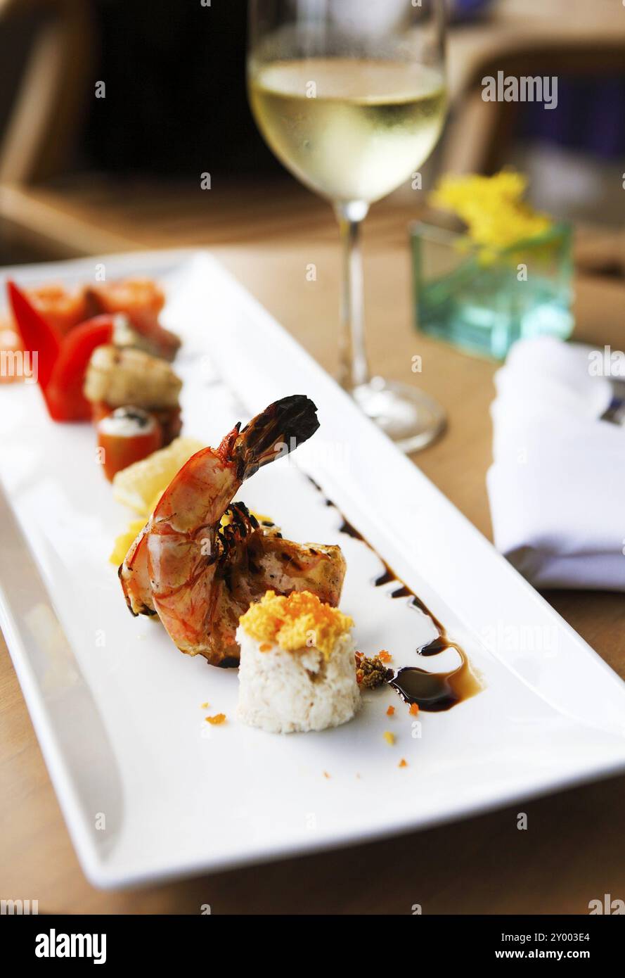 Roll set on the plate served at the restaurant with wine on the table Stock Photo