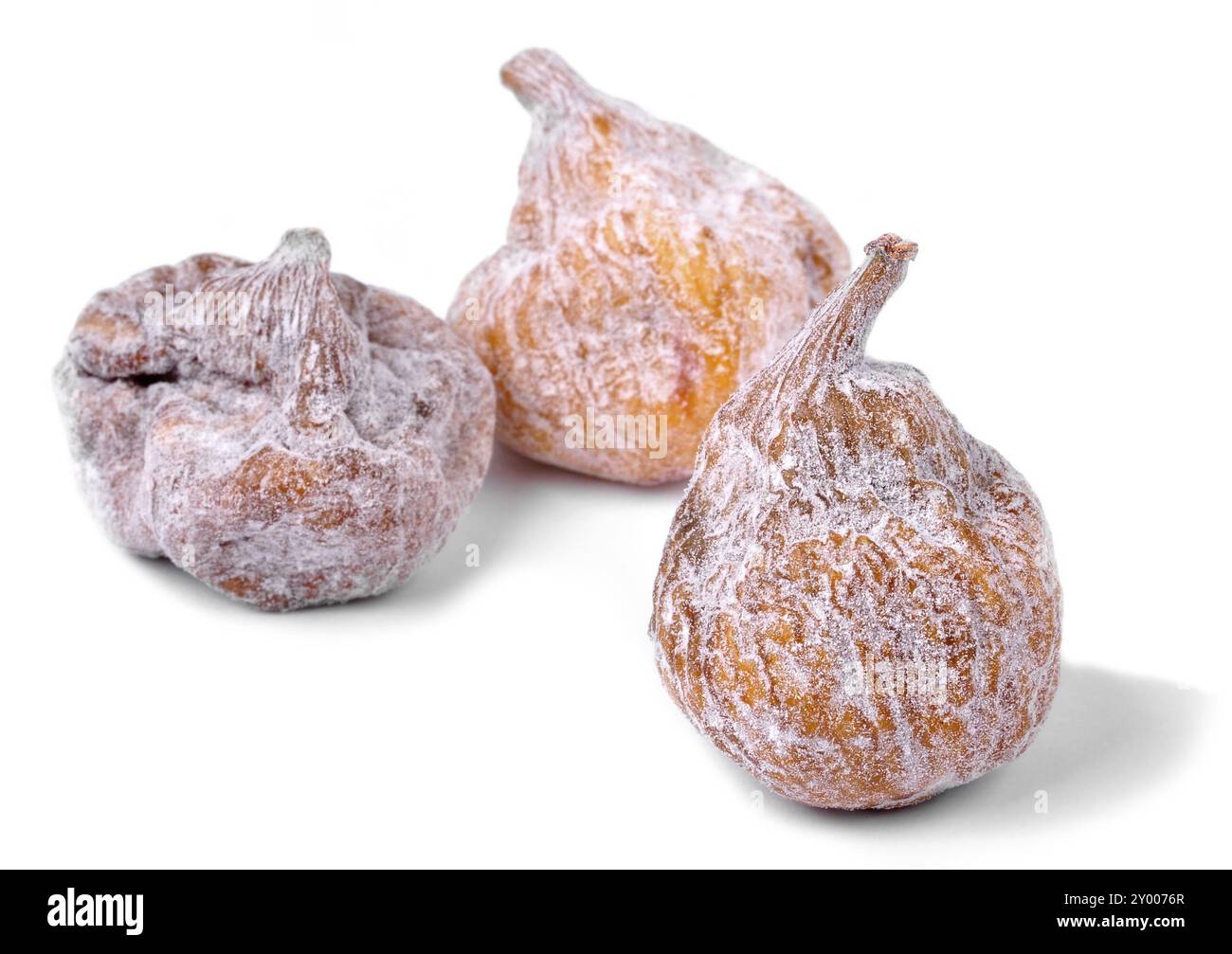 Three dried figs on a white background Stock Photo