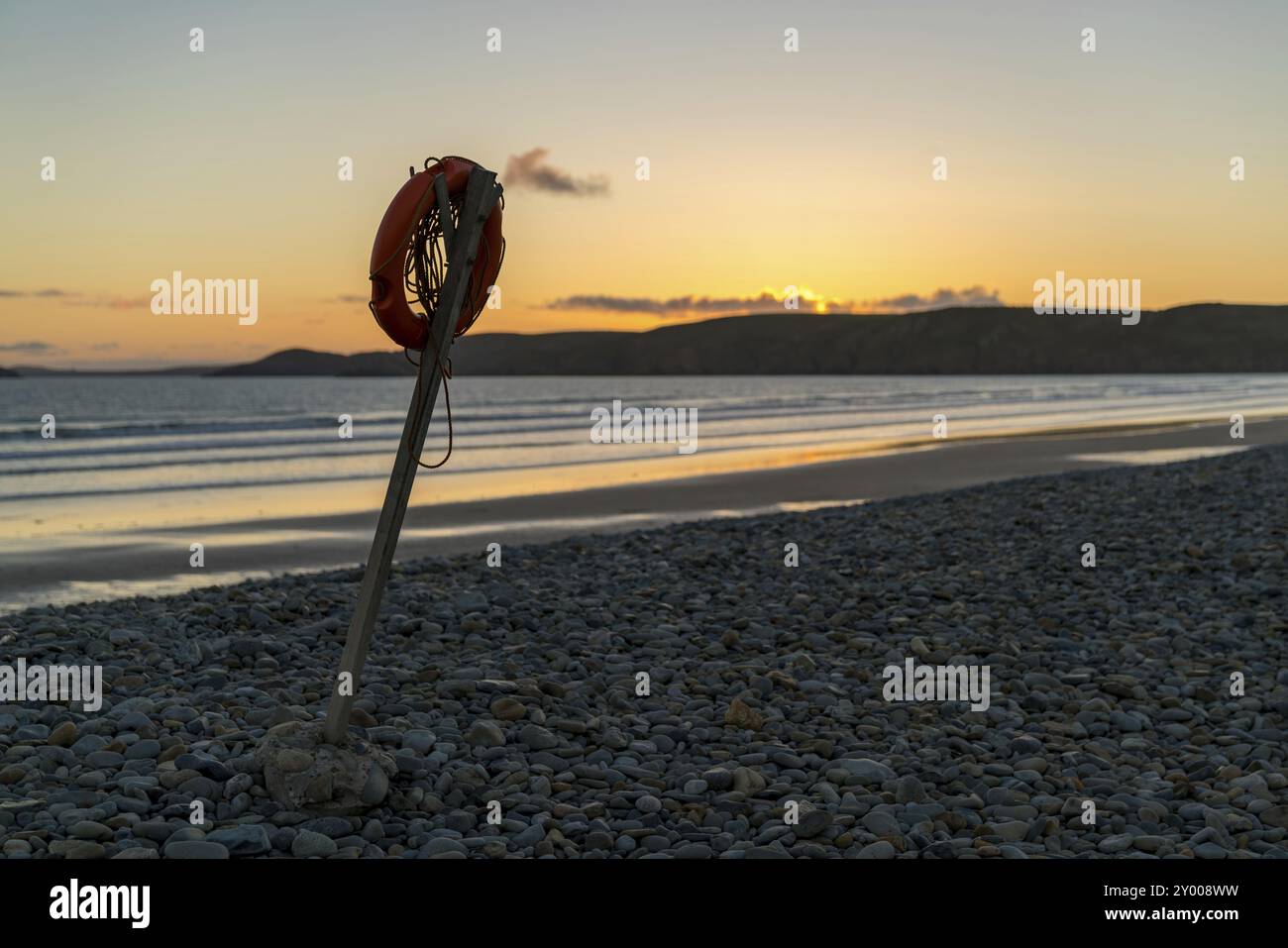 Lifebelt in the evening light on the pebble beach of Newgale, Pembrokeshire, Dyfed, Wales, UK Stock Photo