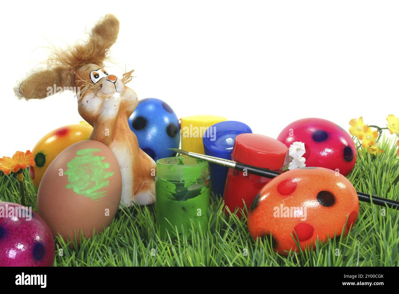 Easter bunny on a flower meadow with colours and eggs Stock Photo - Alamy
