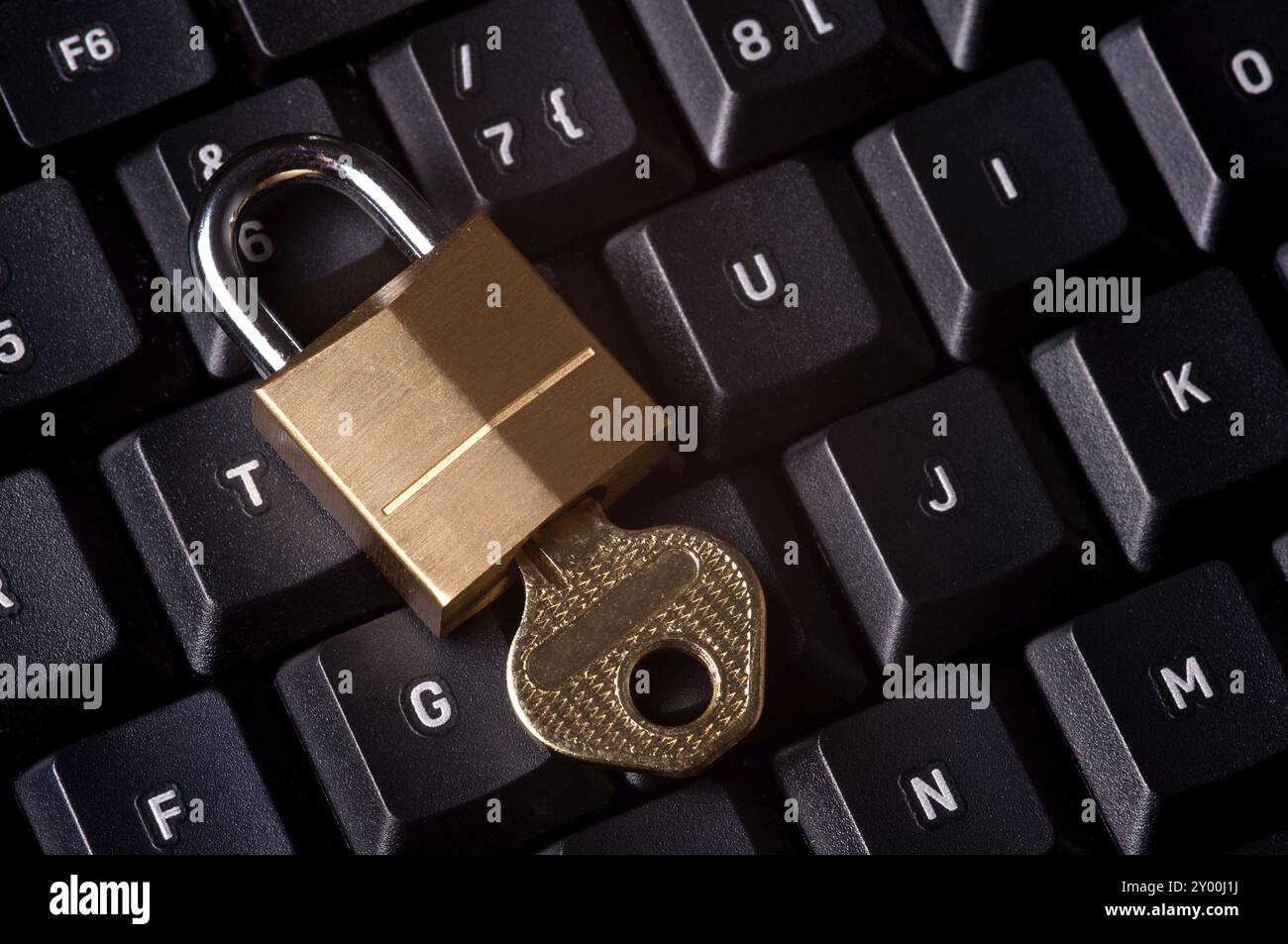 A padlock on top a computer keyboard to represent the concept of computer security Stock Photo