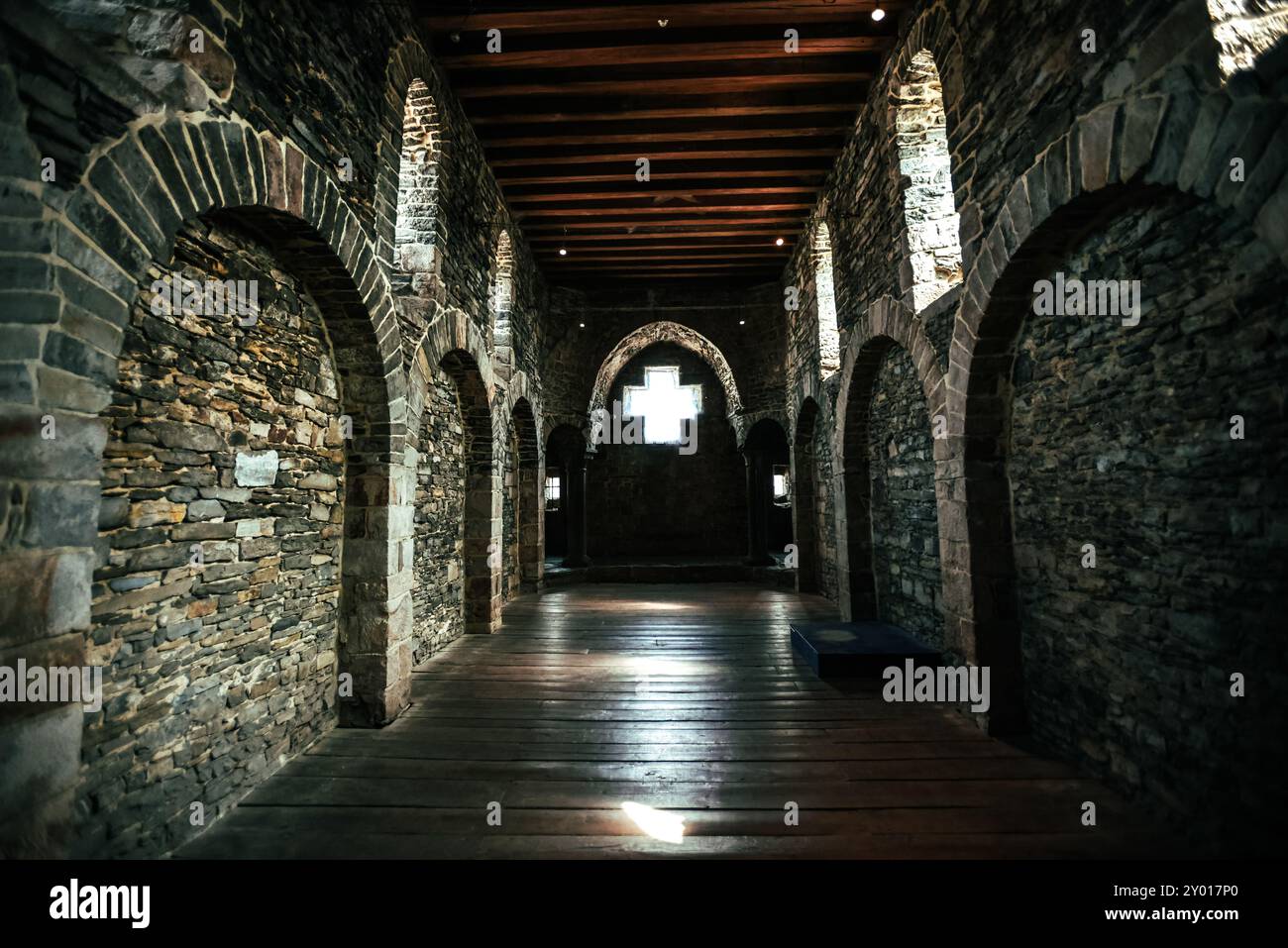 Cross Window in Medieval Stone Hallway Stock Photo