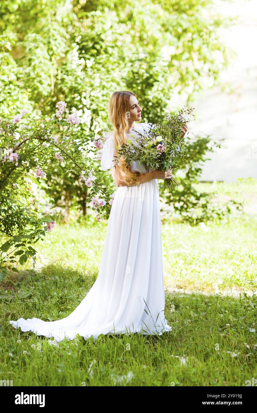 Happy bride with beautiful wedding bouquet of flowers in the style of boho Stock Photo