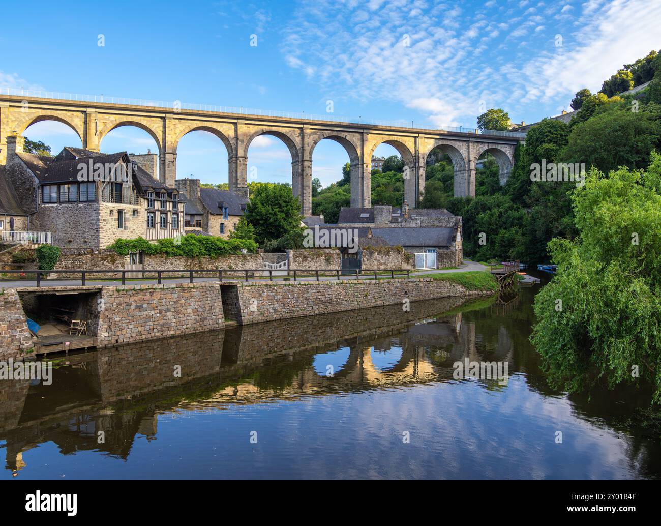 Historical viaduct above the Port de Dinan, reflecting in river Rance ...