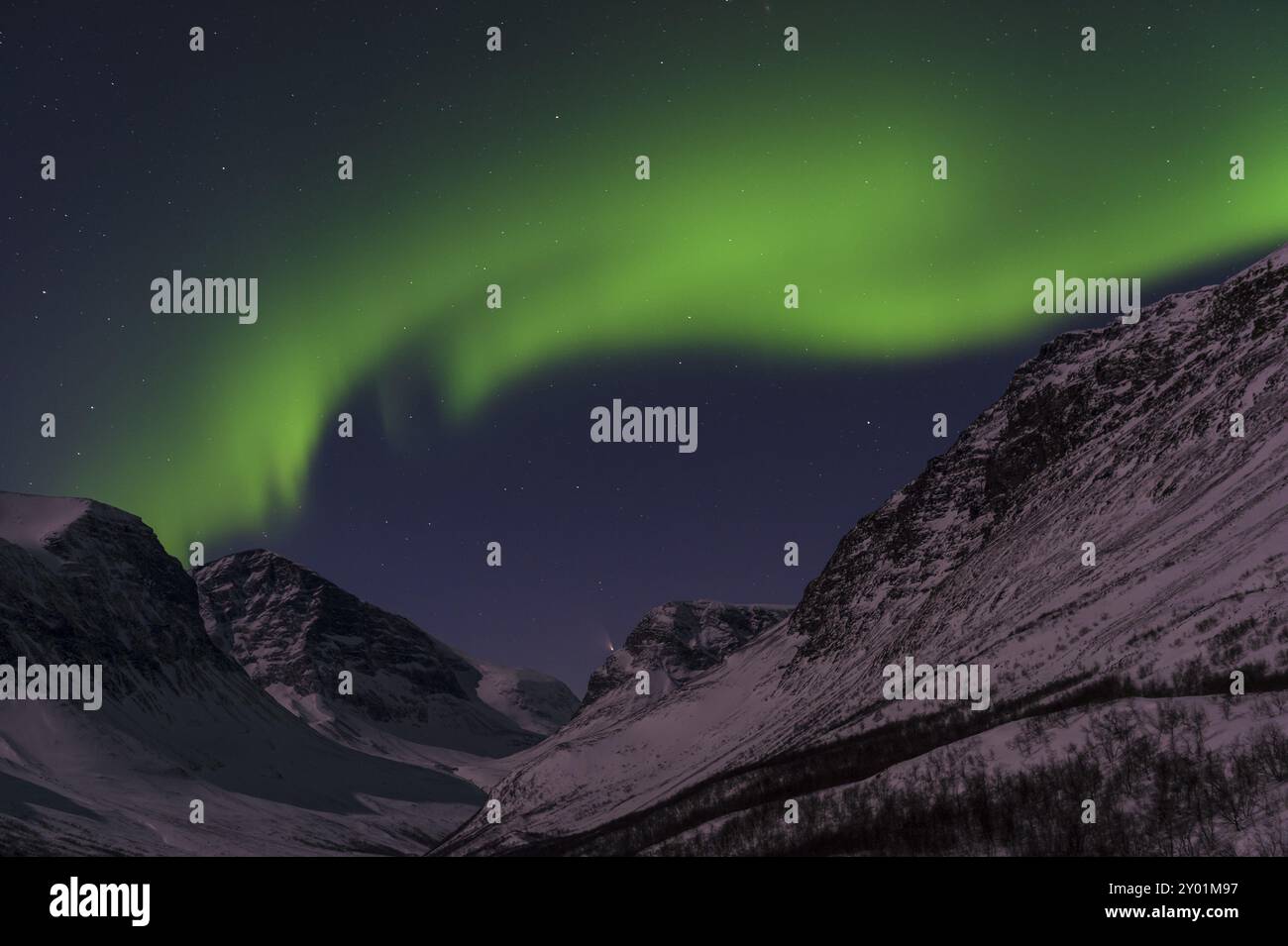 The comet Pan-STARRS and northern lights (aurora borealis) over moonlit mountains in the Vistasdalen valley (Vistasvaggi), Kebnekaisefjaell, Norrbotte Stock Photo