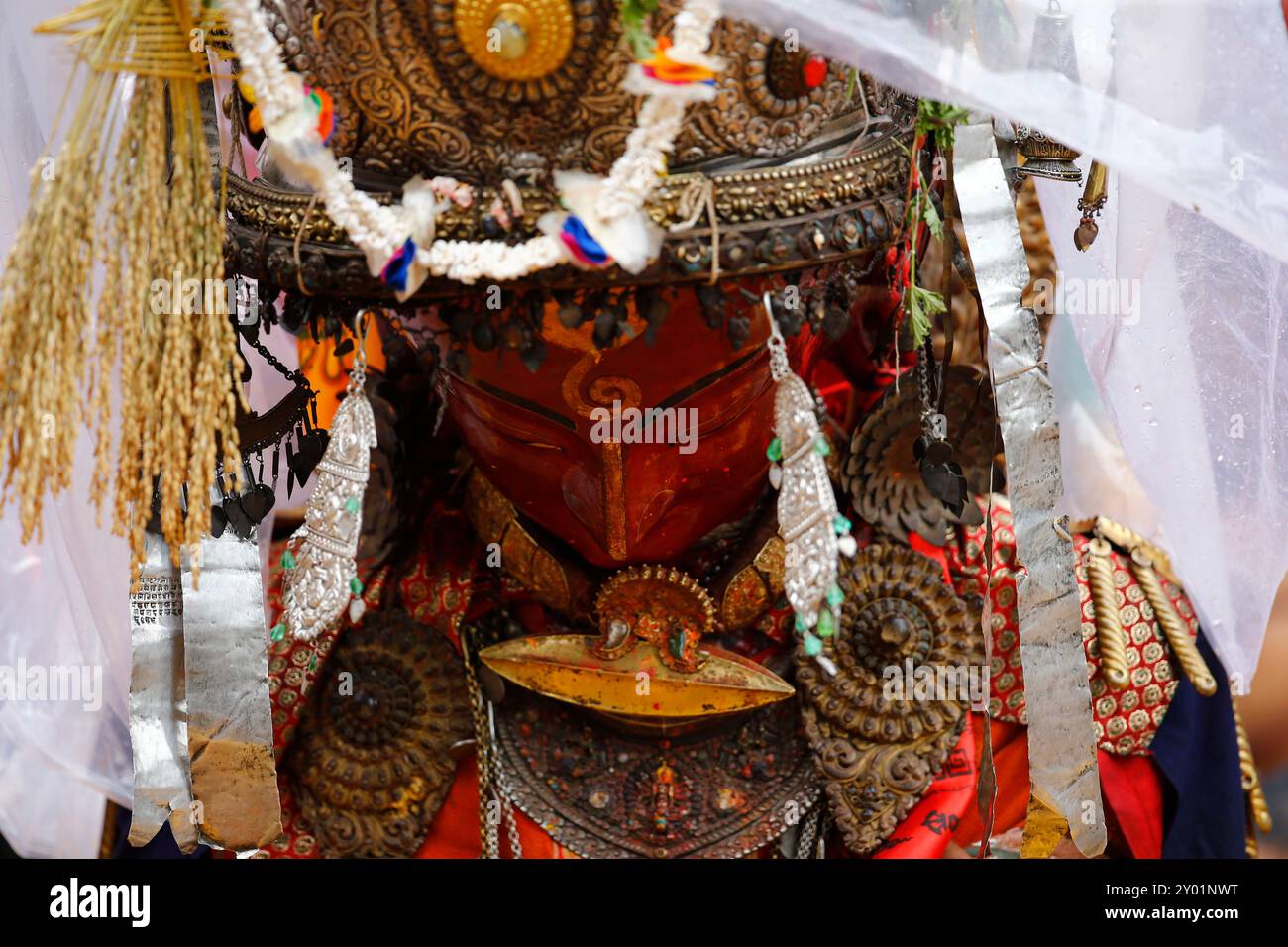 A person concealed inside the idol of Deity Dipankar Buddha dances while parading around the ancient city to receive prayers offered by devotees during the Pancha Dan festival. The festival's major highlights are giving away five elements, also known as five summer gifts including wheat grains, rice grains, salt, money, and fruit for prayers, wishing good health and prosperity. The Buddhists observe Pancha Dan by displaying gigantic antique statues of Deity Dipankar Buddha and devotees worshipping them across the historic city. (Photo by Skanda Gautam/SOPA Images/Sipa USA) Stock Photo