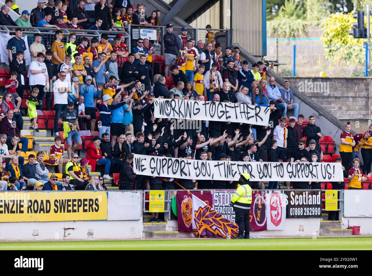 Perth, Scotland. 31 August 2024.  Motherwell fans hold banners protesting recent stadium bans for members of their supporters group  St Johnstone Vs Motherwell - Scottish Premiership  Credit: Raymond Davies / Alamy Live News Stock Photo