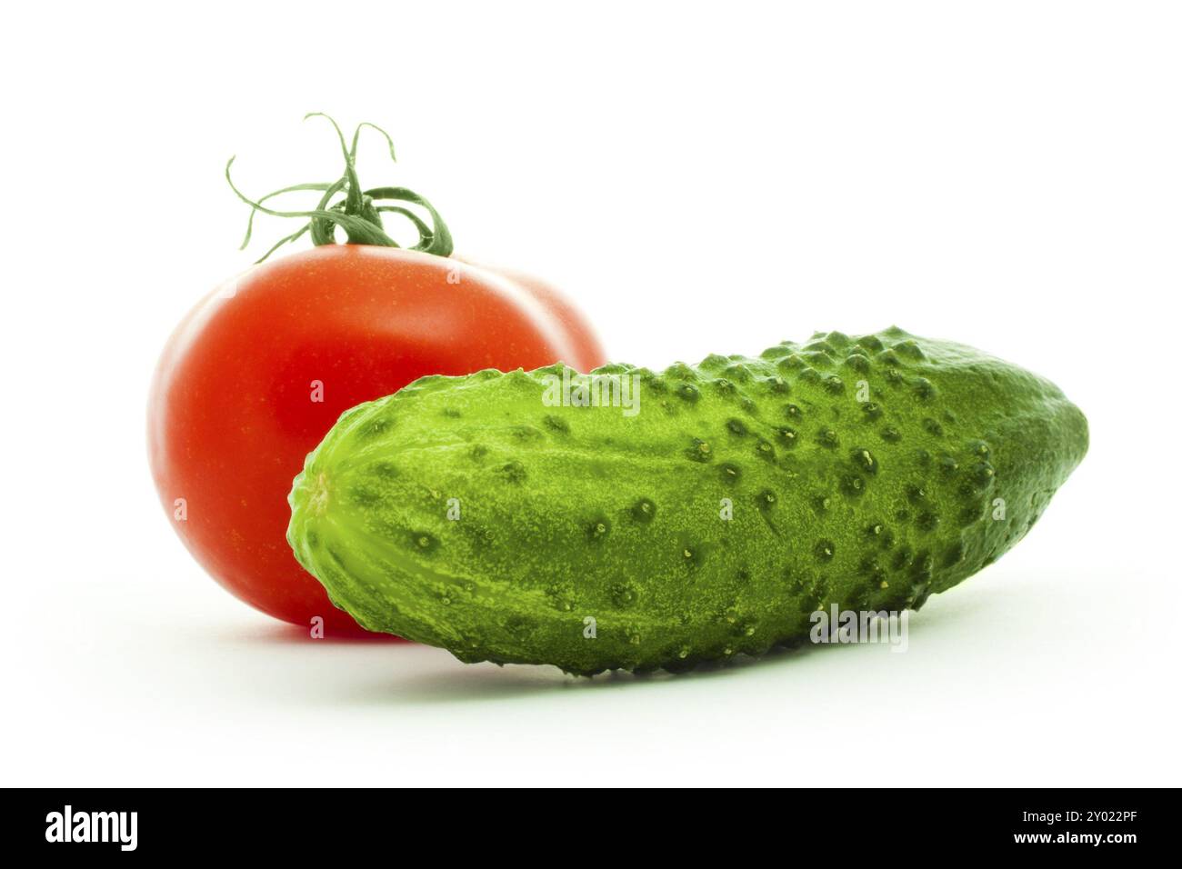 Cucumber and tomato isolated on white Stock Photo - Alamy