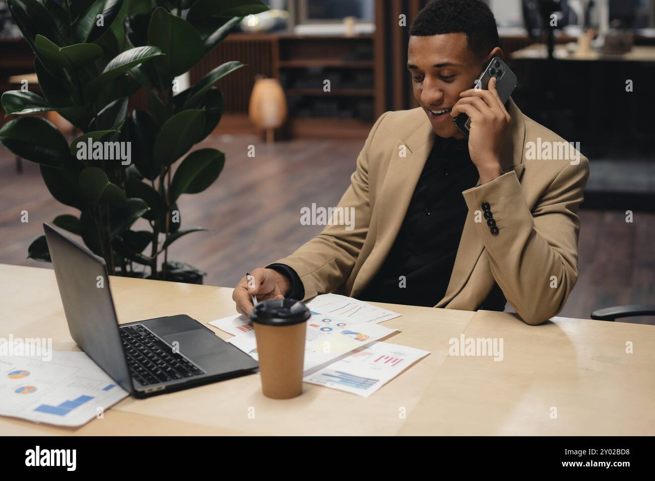 Businessman standing alone in a modern workplace. Stock Photo