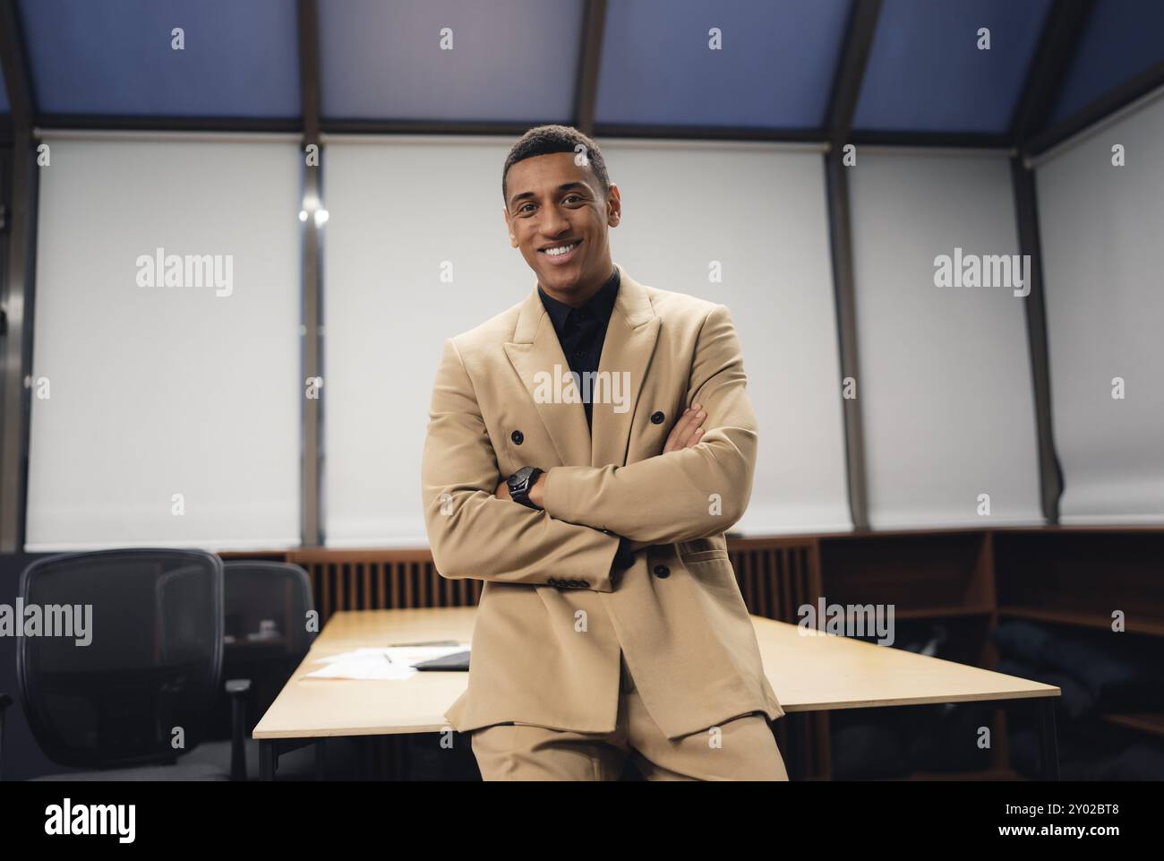 Businessman standing alone in a modern workplace. Stock Photo