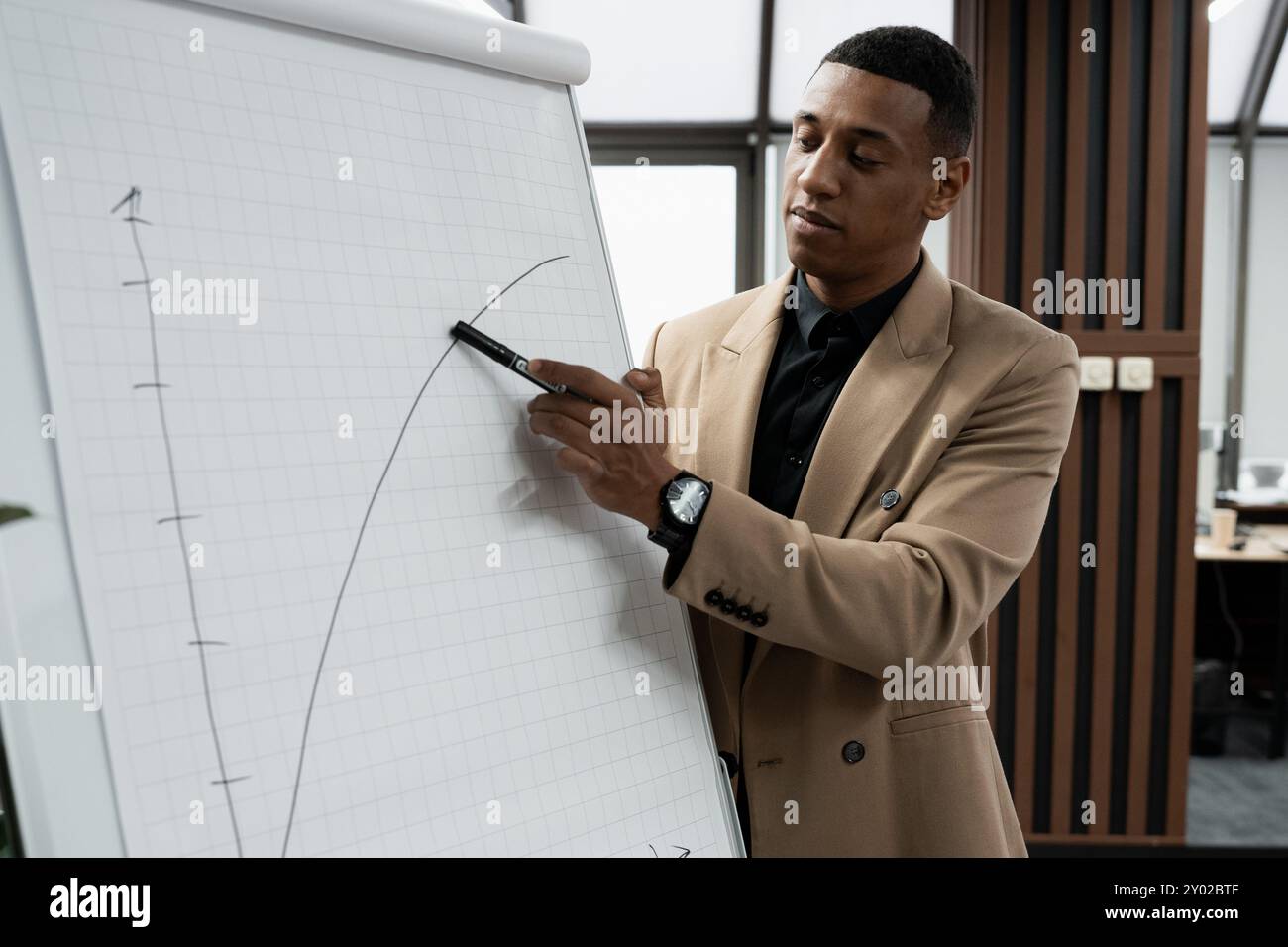 Businessman standing alone in a modern workplace. Stock Photo