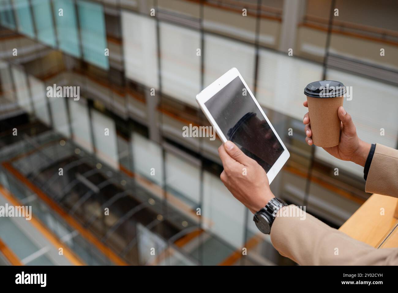 Businessman standing alone in a modern workplace. Stock Photo