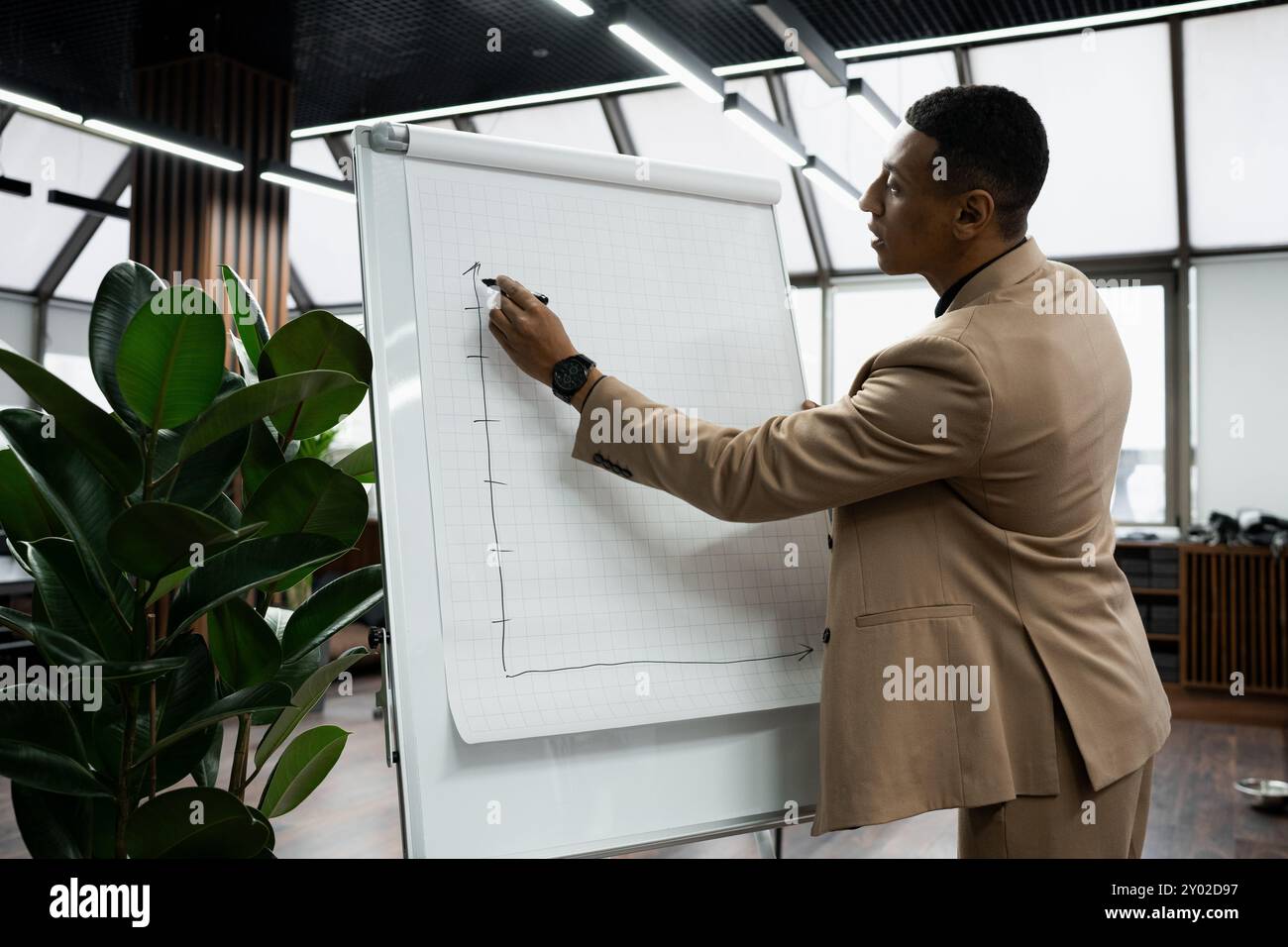 Businessman standing alone in a modern workplace. Stock Photo