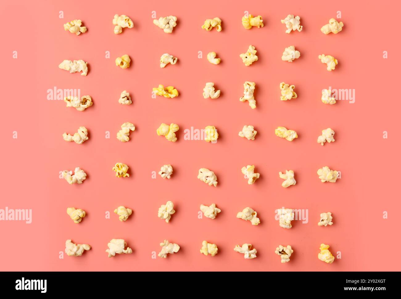 Crispy popcorn on pink background Stock Photo