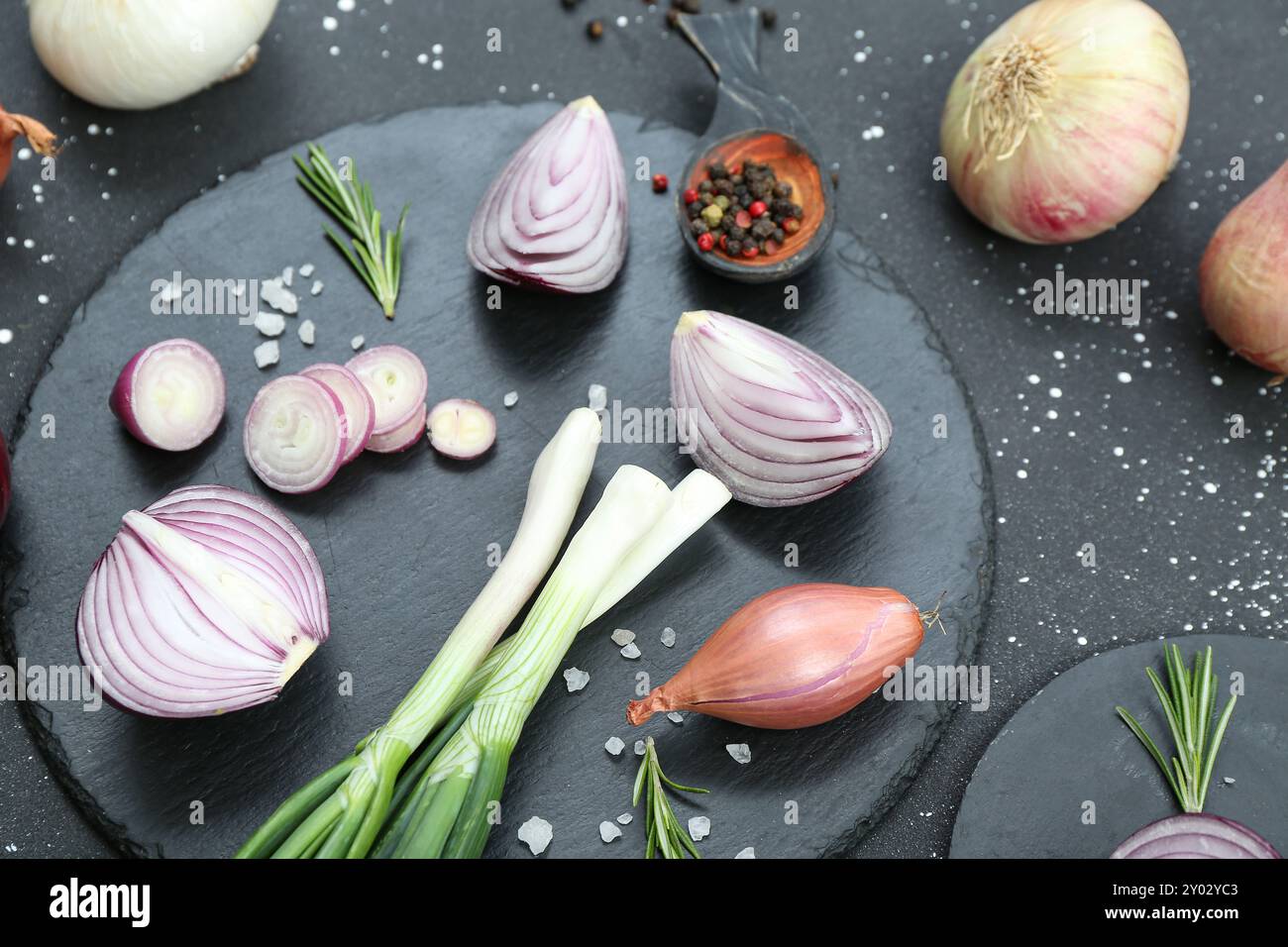 Boards with different kinds of onion on grunge black background Stock ...