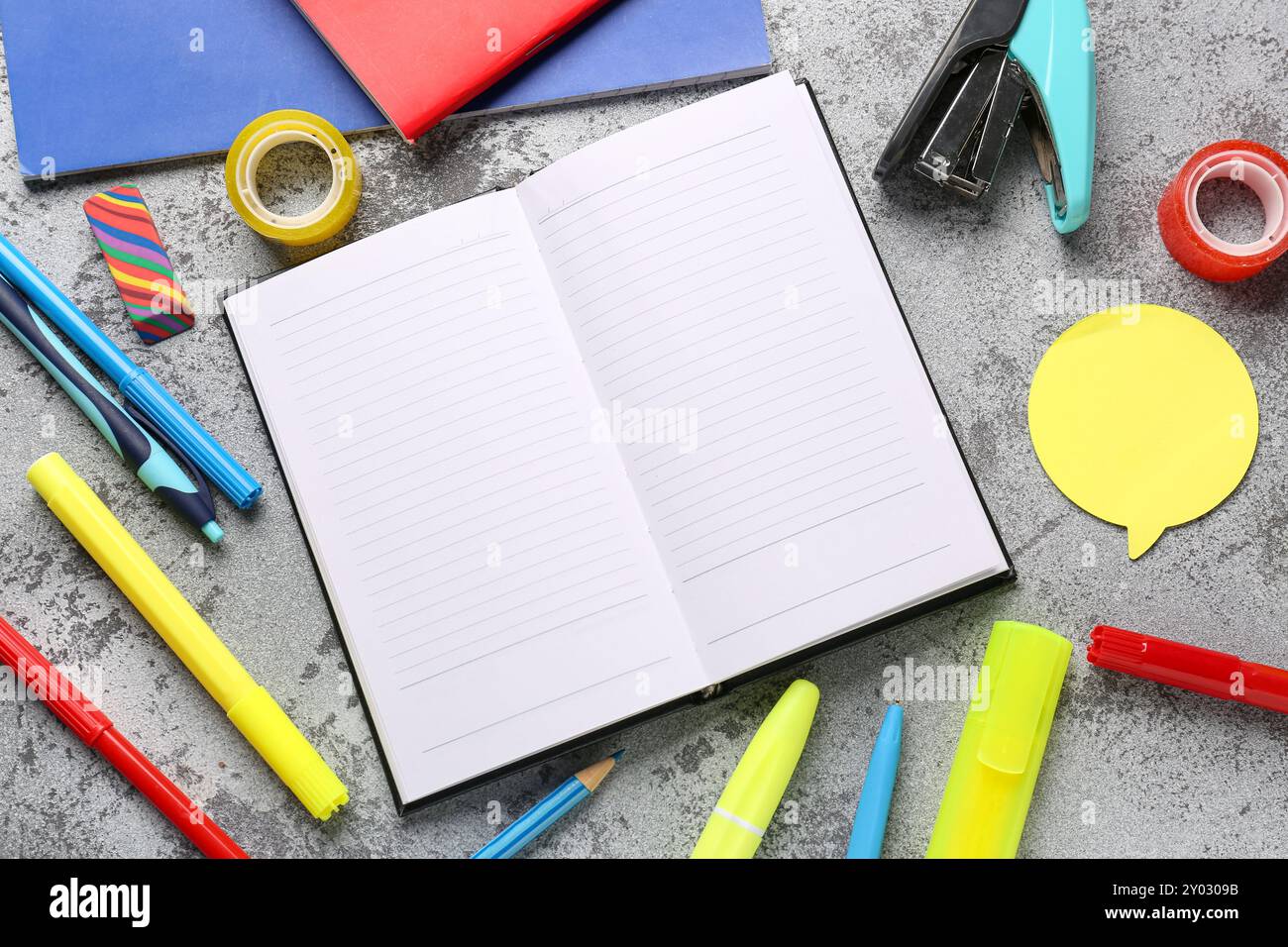 Notebooks with different stationery on grunge grey background Stock Photo
