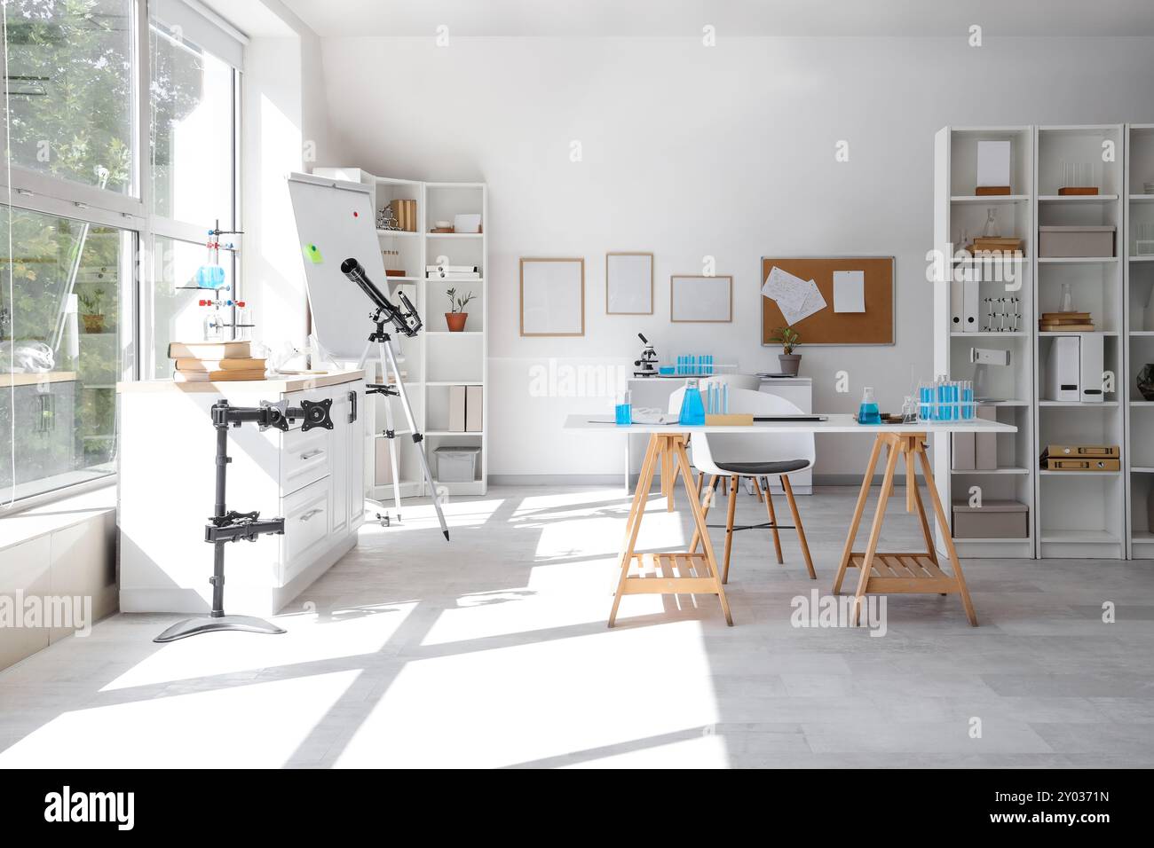Interior of laboratory with tables, shelf units and chemical equipment ...