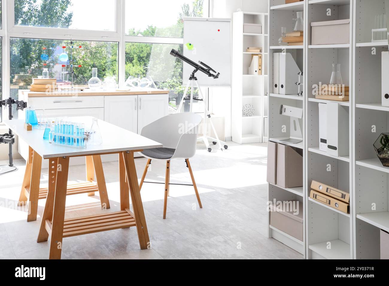 Interior of laboratory with workplace, shelf units and chemical ...