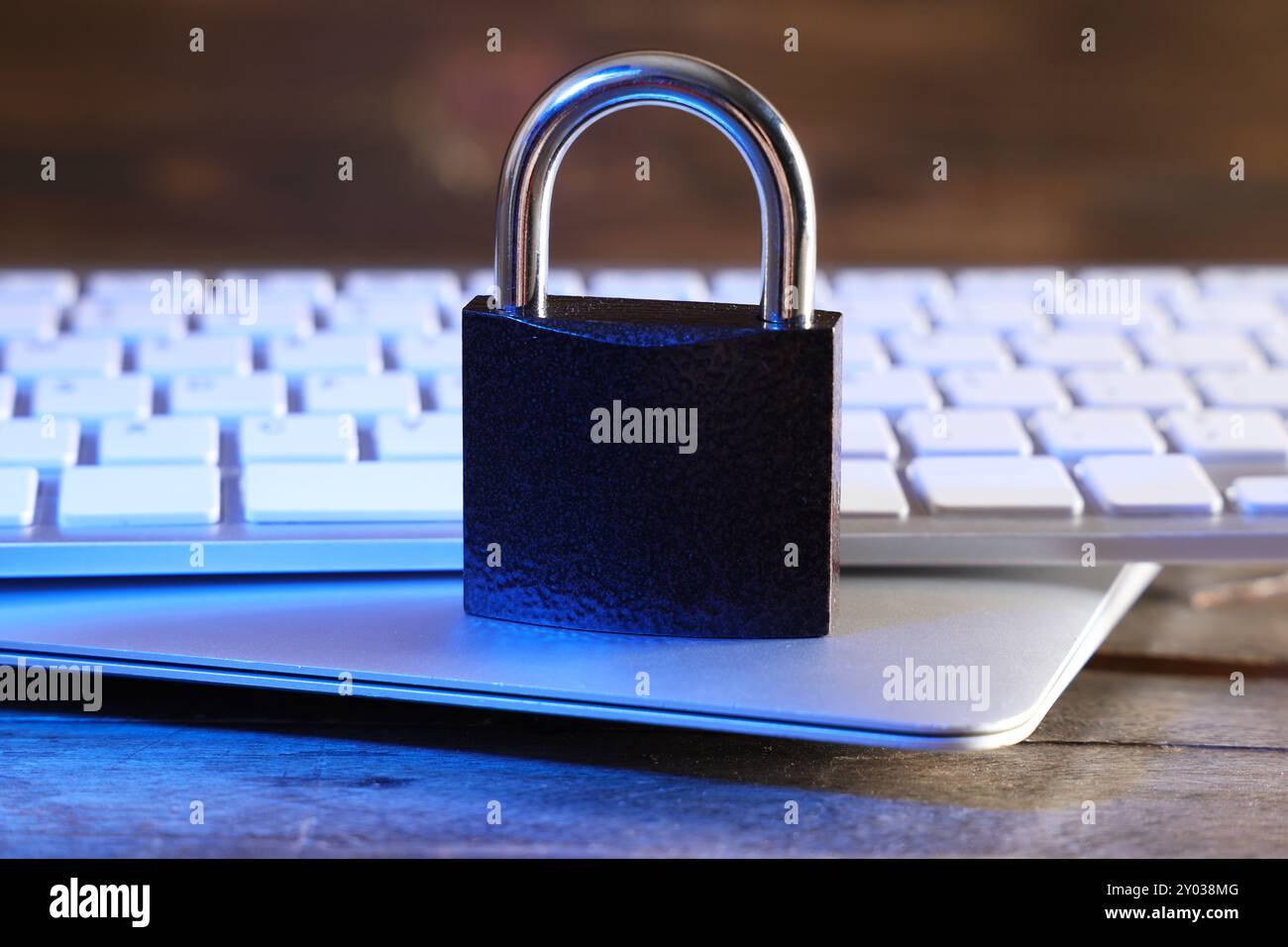 Padlock with laptop and computer keyboard on table, closeup. Cyber security concept Stock Photo