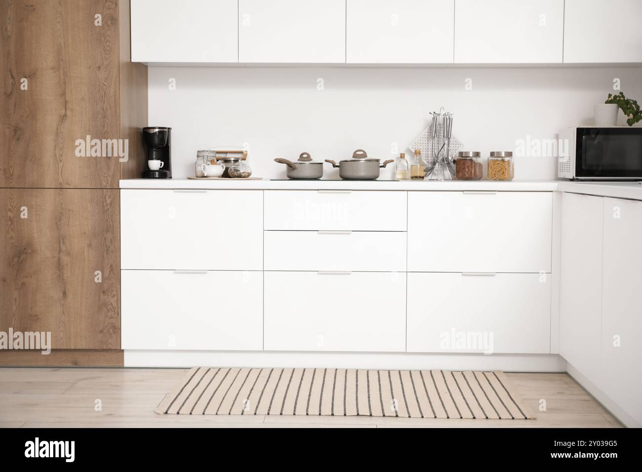 Interior of light kitchen with white counters and utensils Stock Photo ...