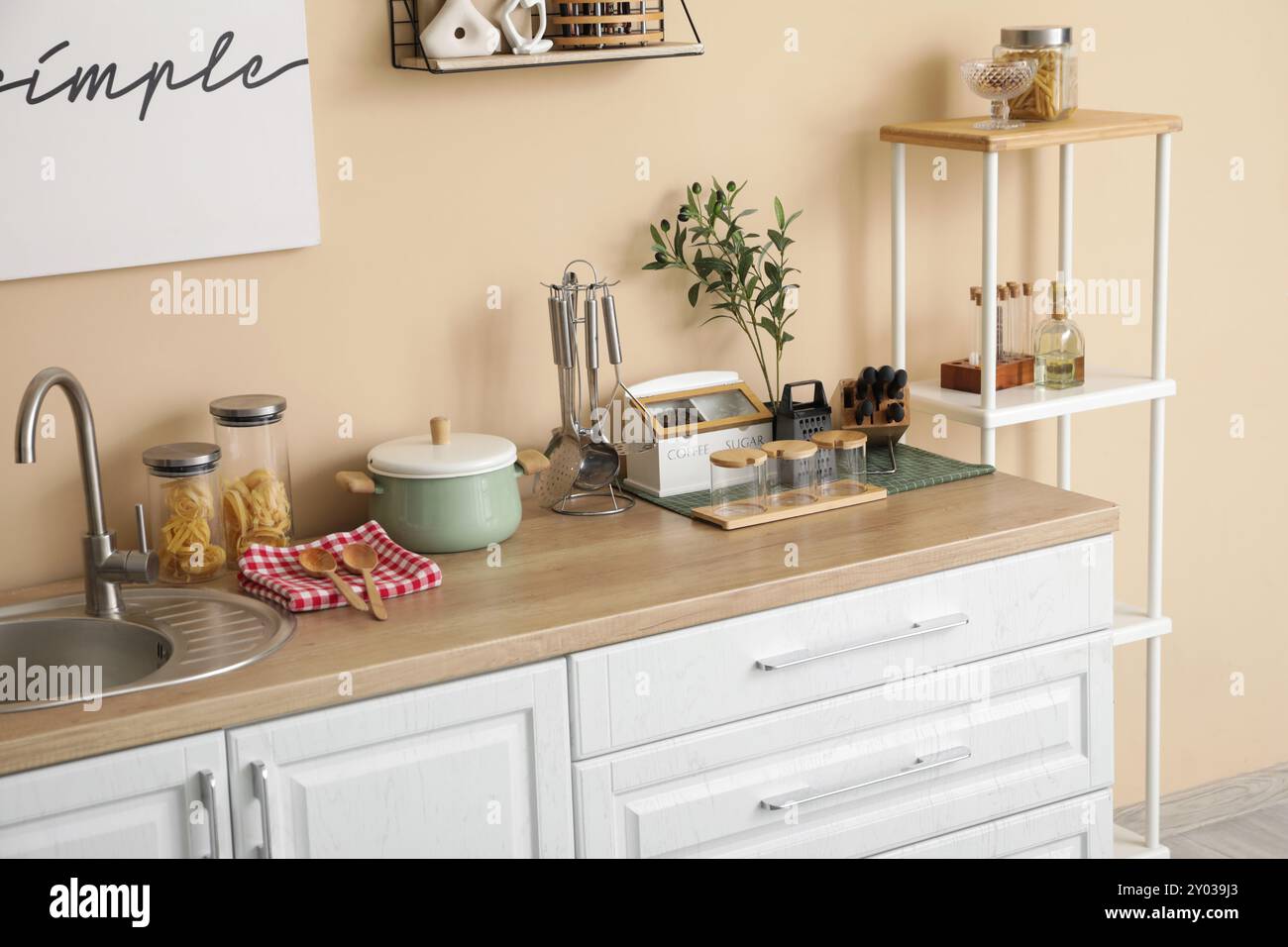 Interior of kitchen with counters, shelf unit and utensils Stock Photo ...