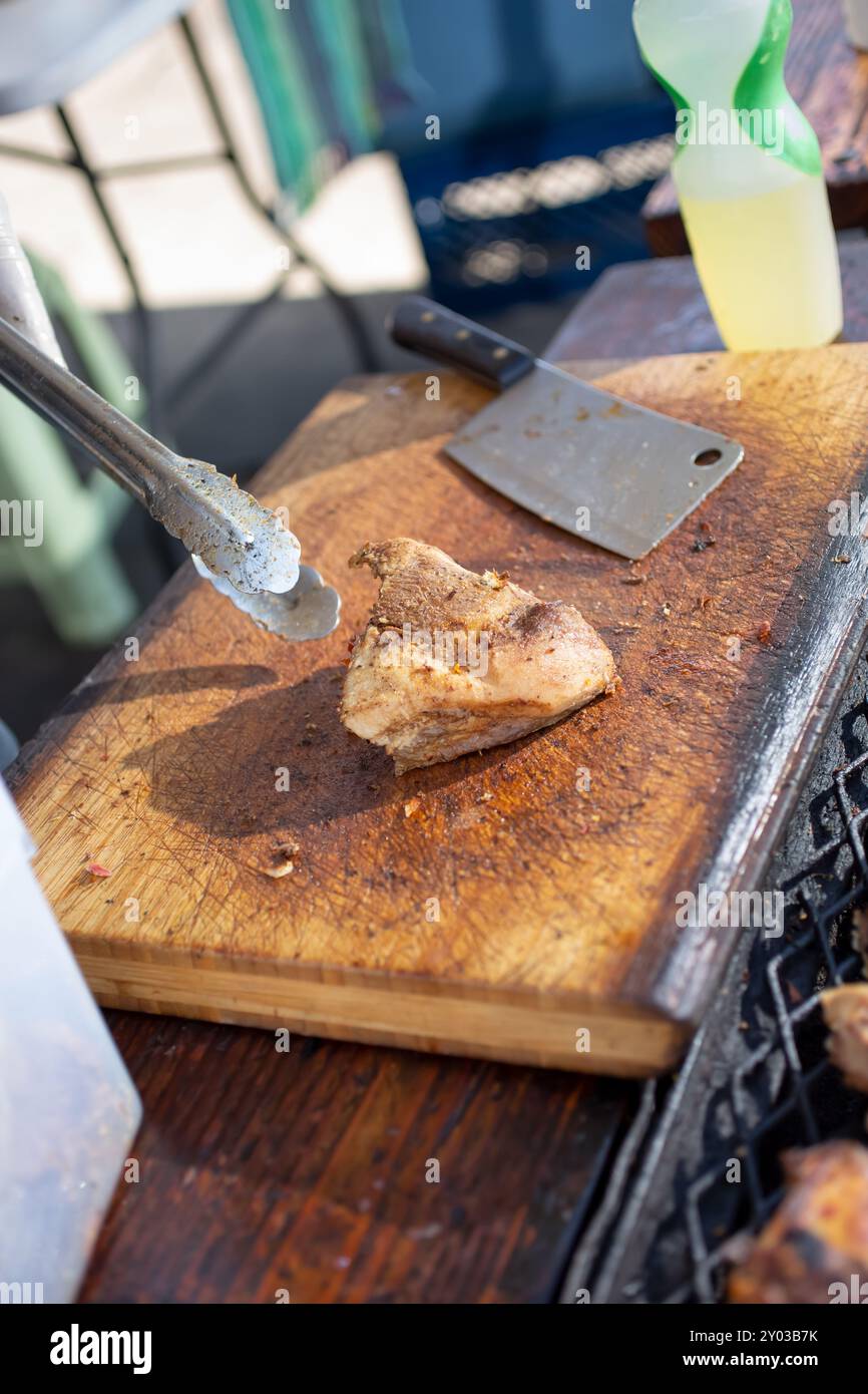 A view of a butcher block with a portion of cooked carnitas. Stock Photo