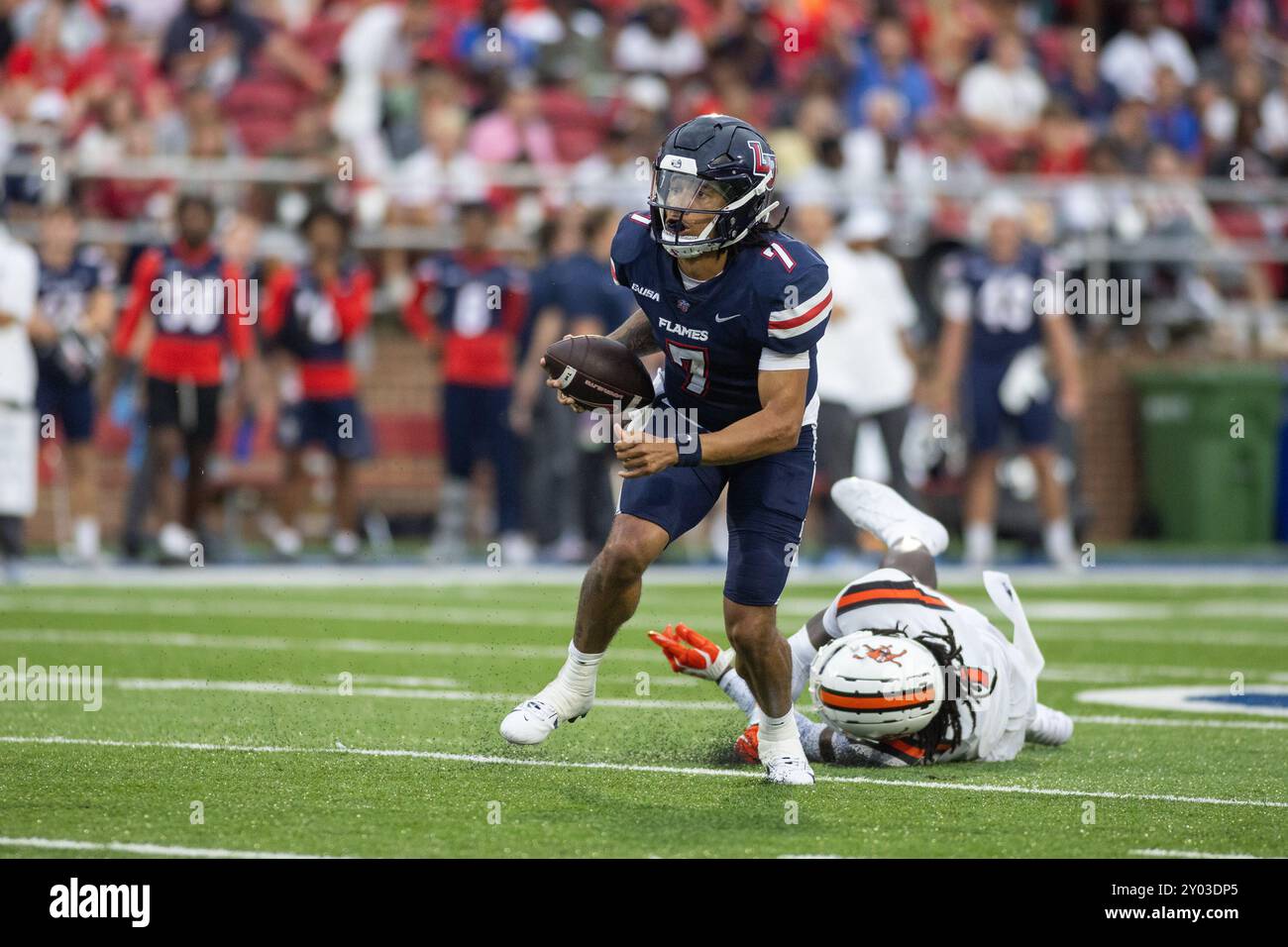 Liberty quarterback Kaidon Salter (7) scrambles with the