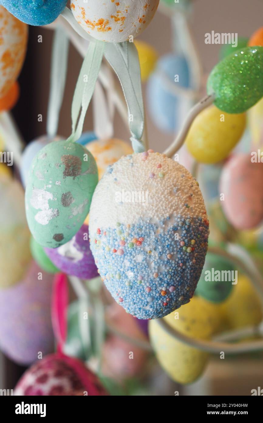 easter concept with multi color egg hanging on a decorative tree Stock Photo