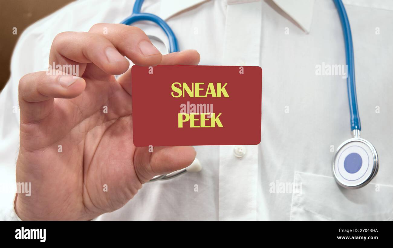 Conceptual sneak peek symbol. Copy space. SNEAK PEEK words written on the red card in the man's hand Stock Photo