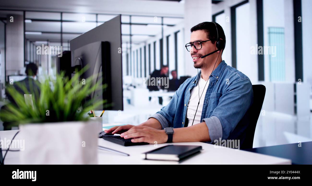 Call Center Operator Sitting Working At Office Stock Photo