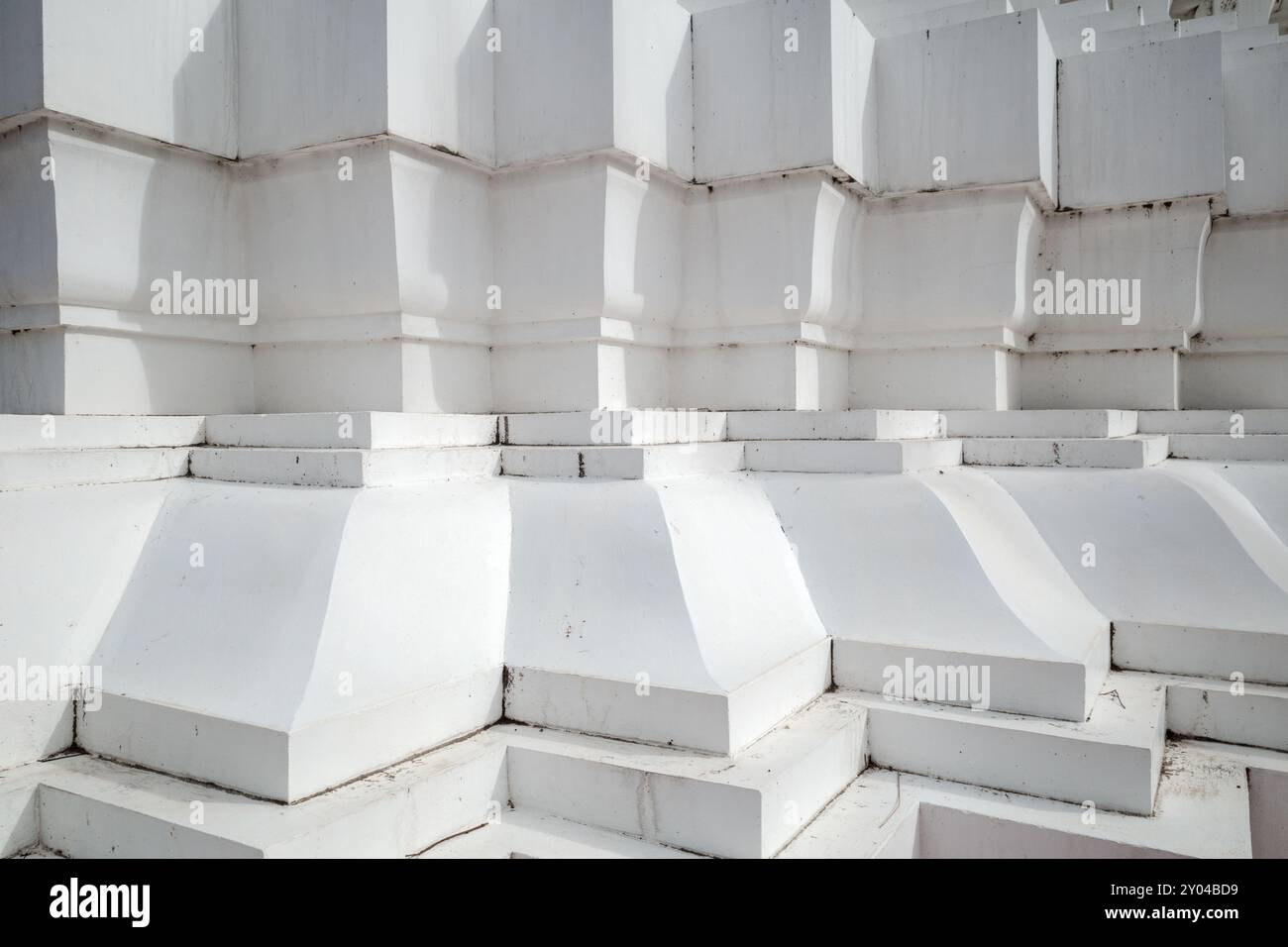 A close-up view of a white architectural structure featuring geometric shapes and repetitive patterns. Stock Photo