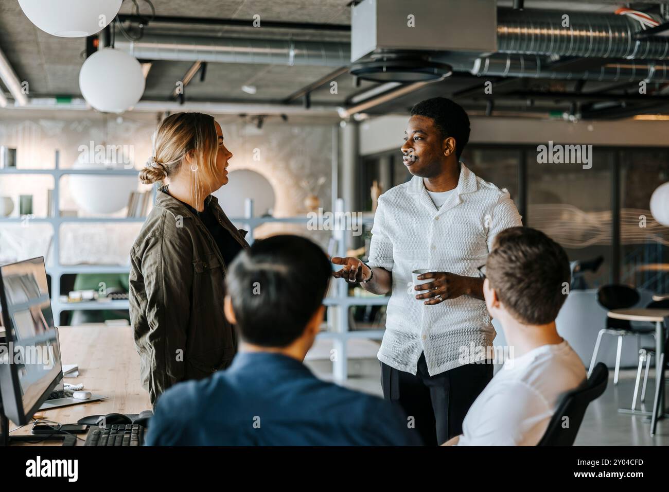 Male and female computer programmers discussing ideas at office Stock Photo